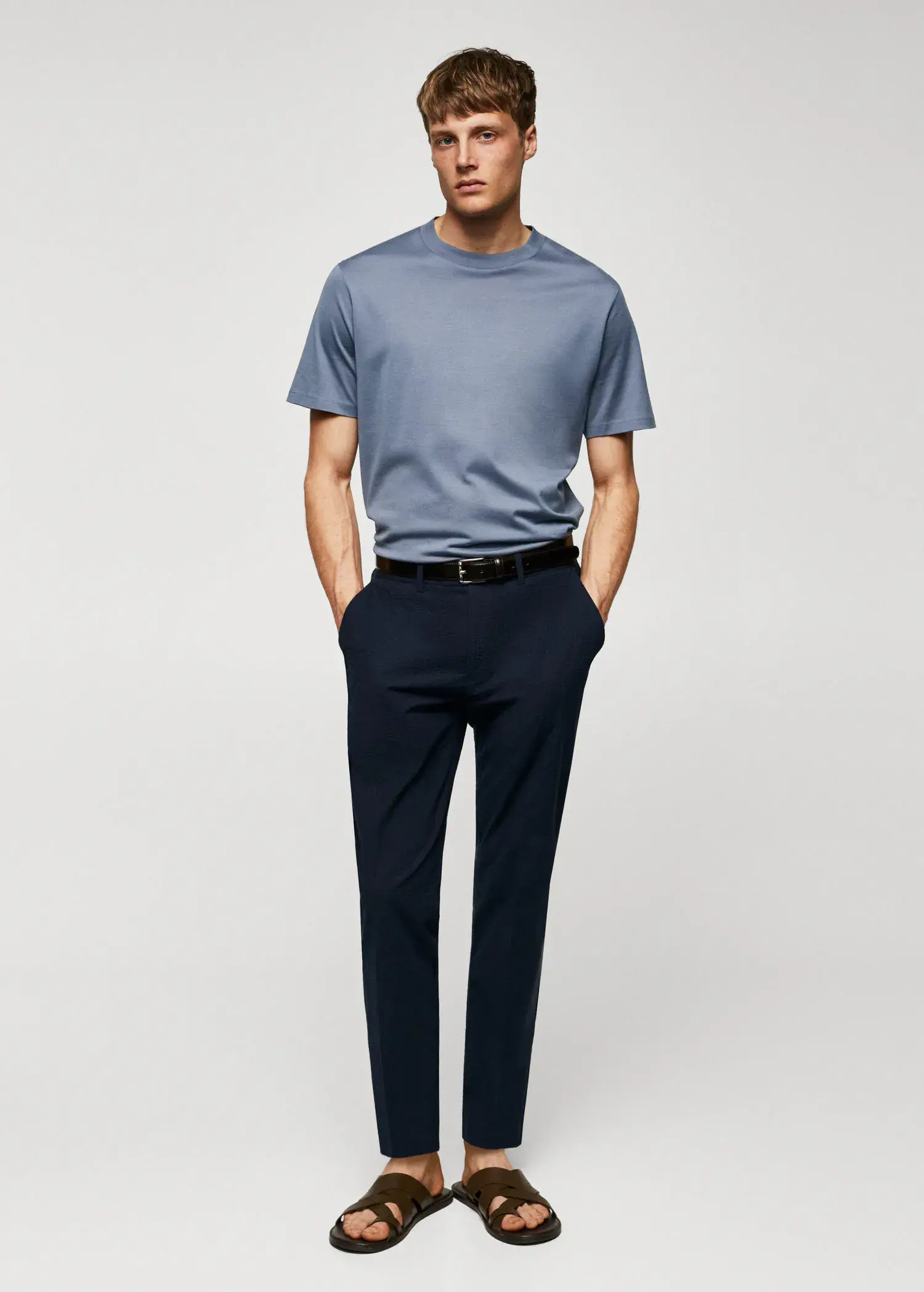 Mango Mercerised regular-fit t-shirt. a man standing with his hands in his pockets. 
