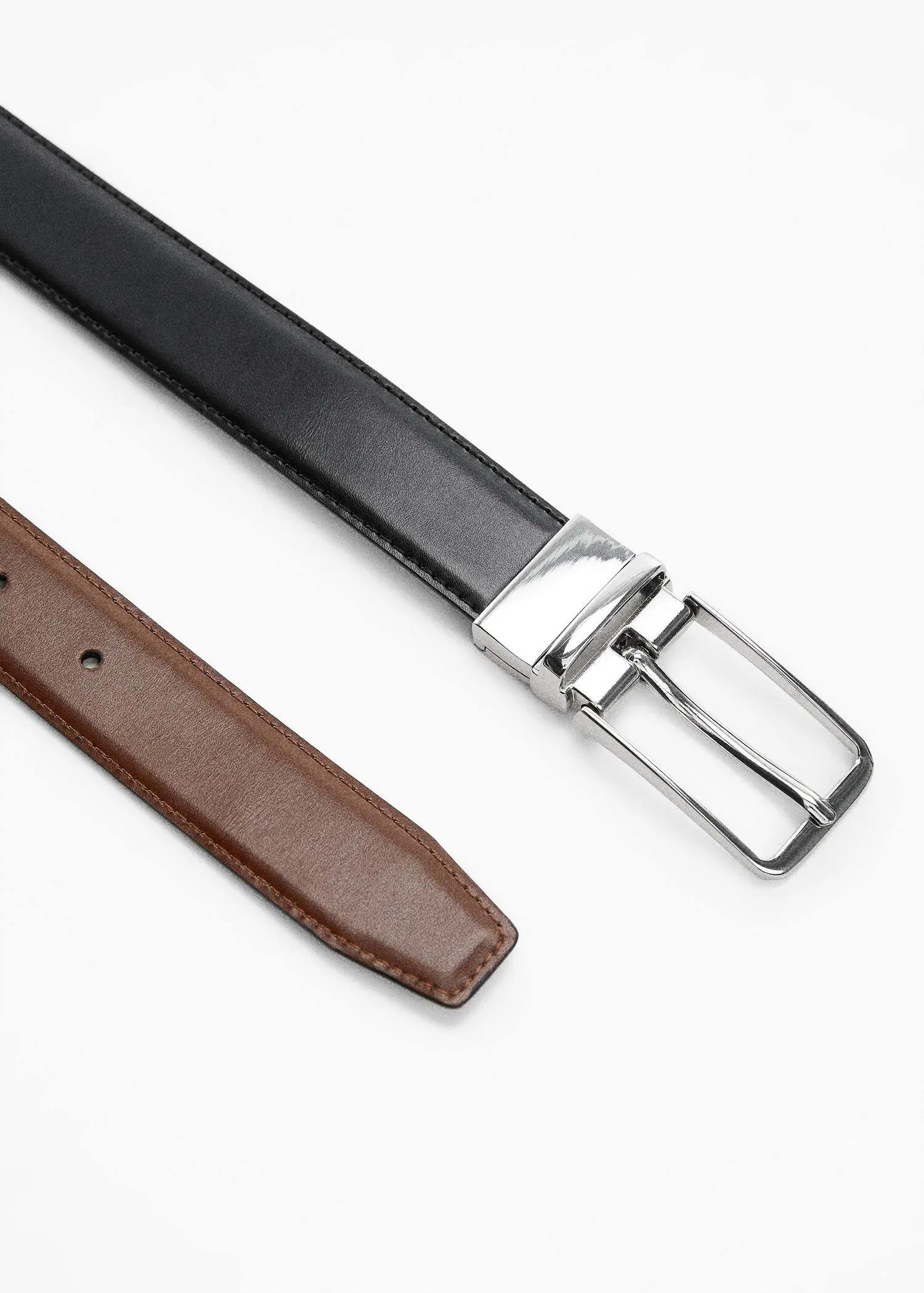 Mango Leather reversible belt. a close up of a leather belt and a metal buckle. 