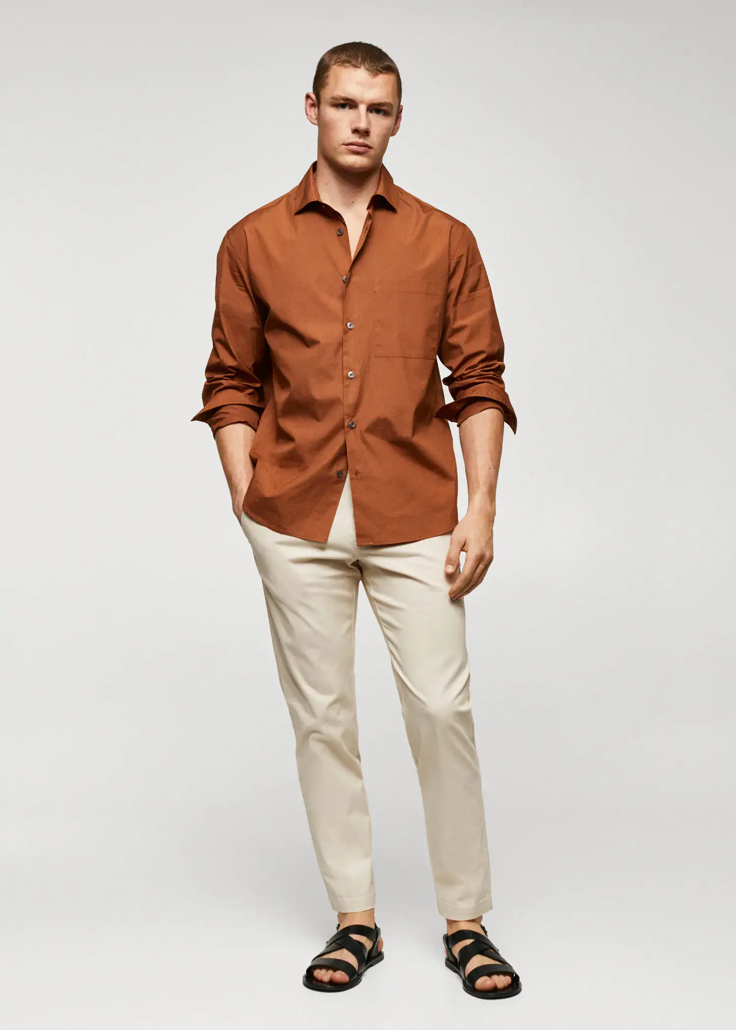 Mango Cotton tapered crop pants. a man wearing a brown shirt and white pants. 