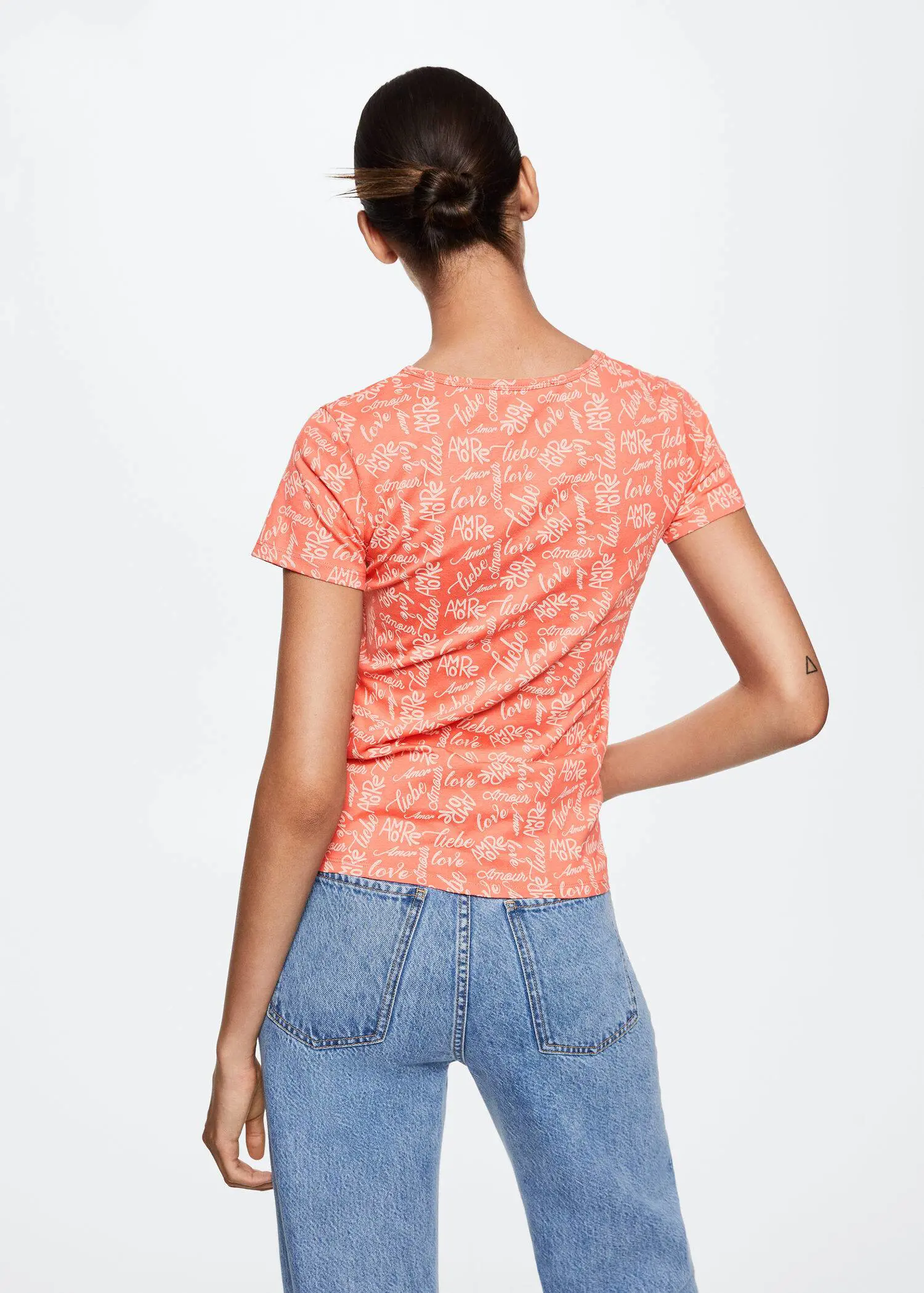 Mango Printed cotton-blend T-shirt. the back of a woman wearing jeans and a t-shirt. 