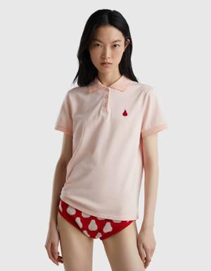 pink polo with pear embroidery
