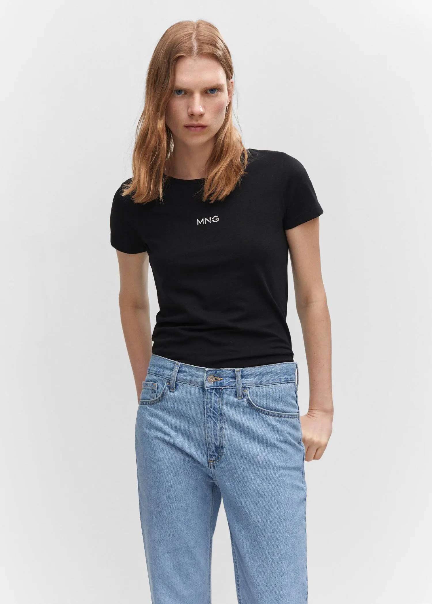Mango Metallic logo T-shirt. a woman wearing a black t-shirt and jeans. 