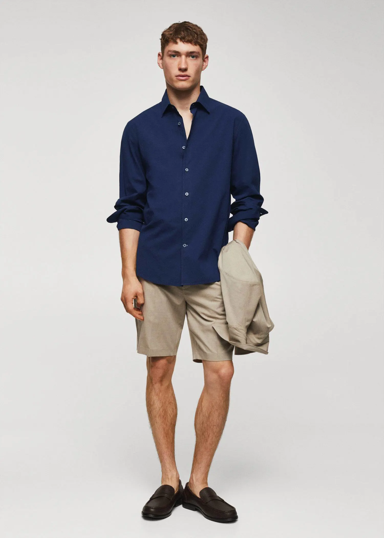 Mango Slim-fit cotton seersucker shirt. a man in a blue shirt and shorts. 