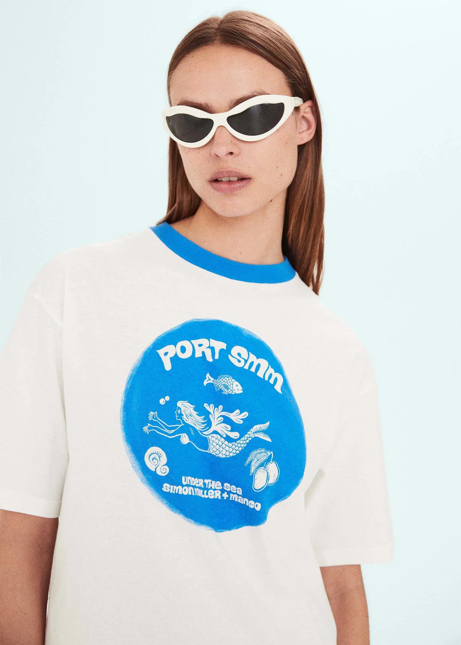 Mango Printed oversize t-shirt. a woman wearing sunglasses and a white t-shirt. 