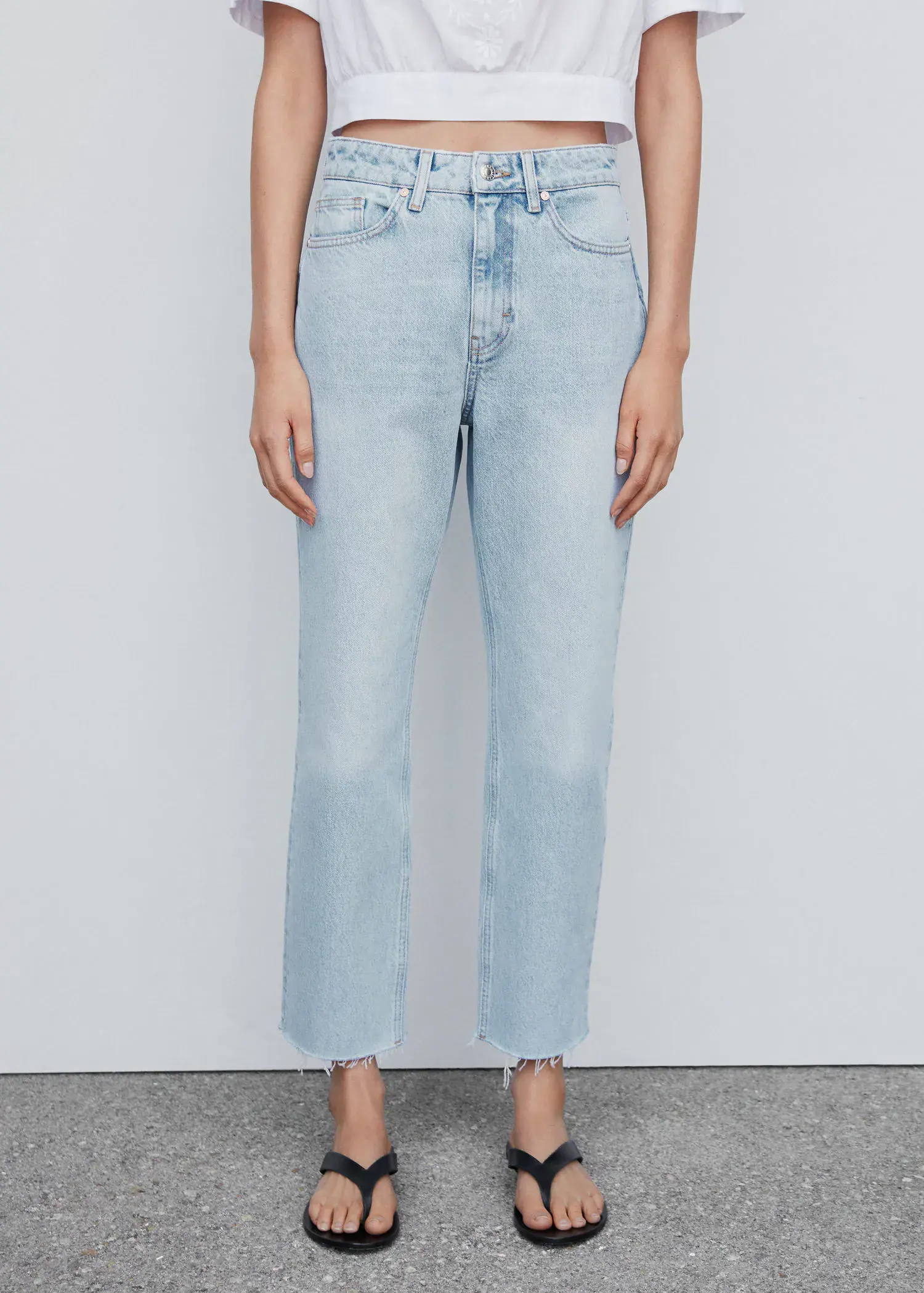 Mango High waist straight jeans. a person standing in front of a white wall. 