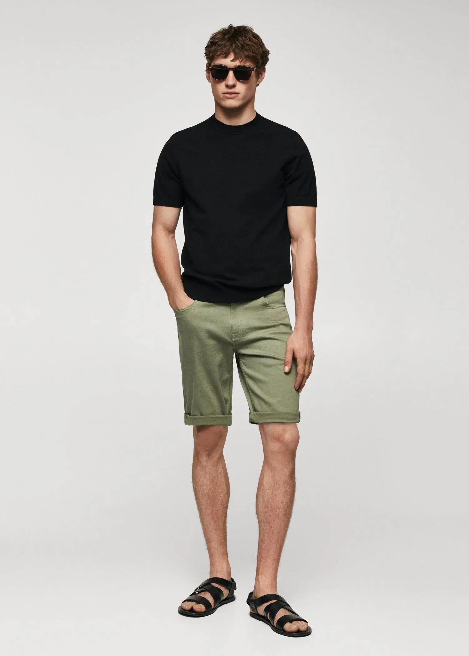 Mango Slim-fit denim bermuda shorts. a man in black shirt and green shorts. 