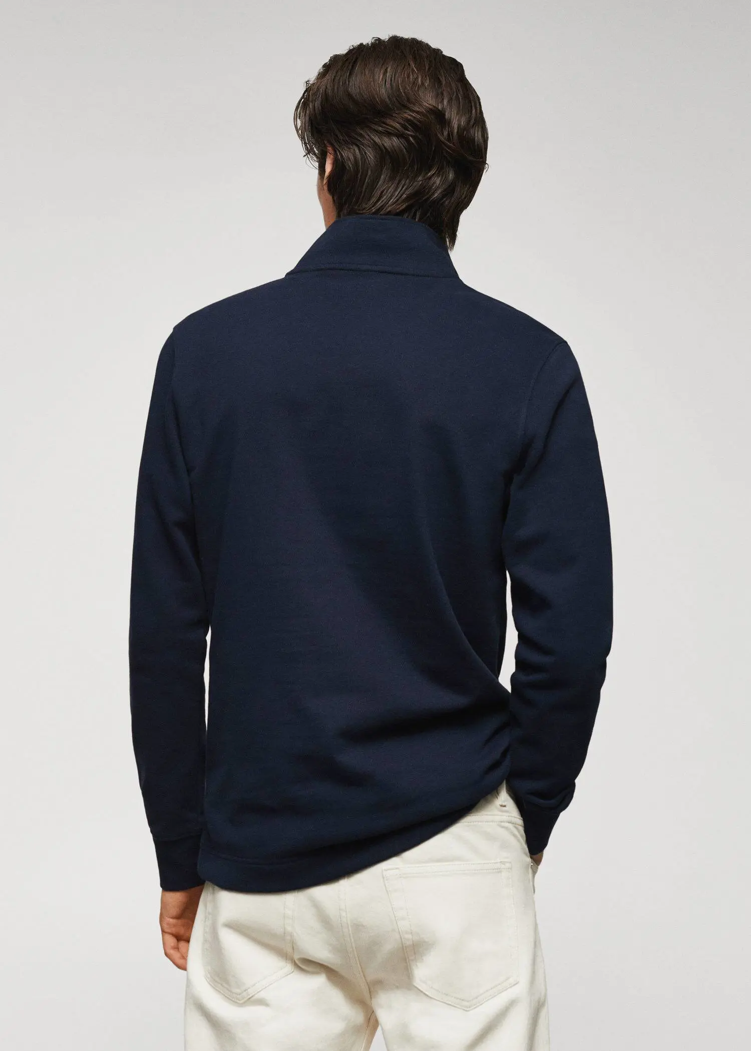 Mango Cotton sweatshirt with zip neck. a man wearing a navy blue jacket and white pants. 