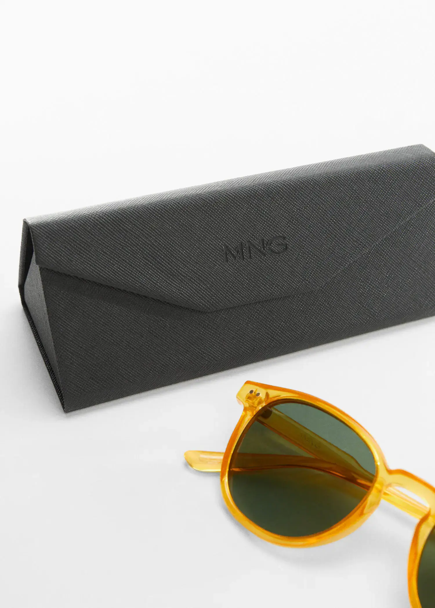 Mango Polarised sunglasses. a pair of sunglasses sitting on top of a table next to a case. 