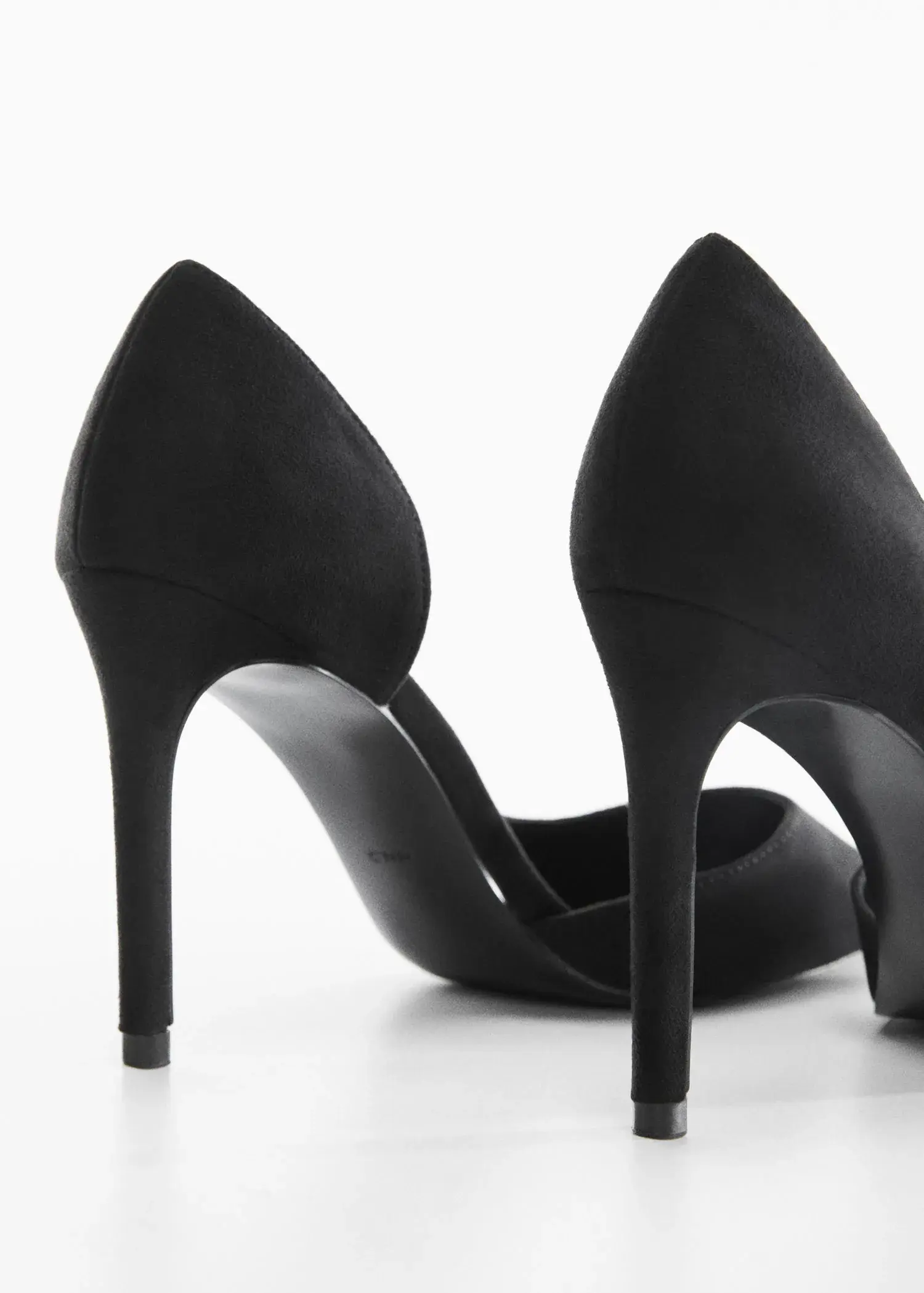 Mango Asymmetrical heeled shoes. a close up of a pair of black high heels. 