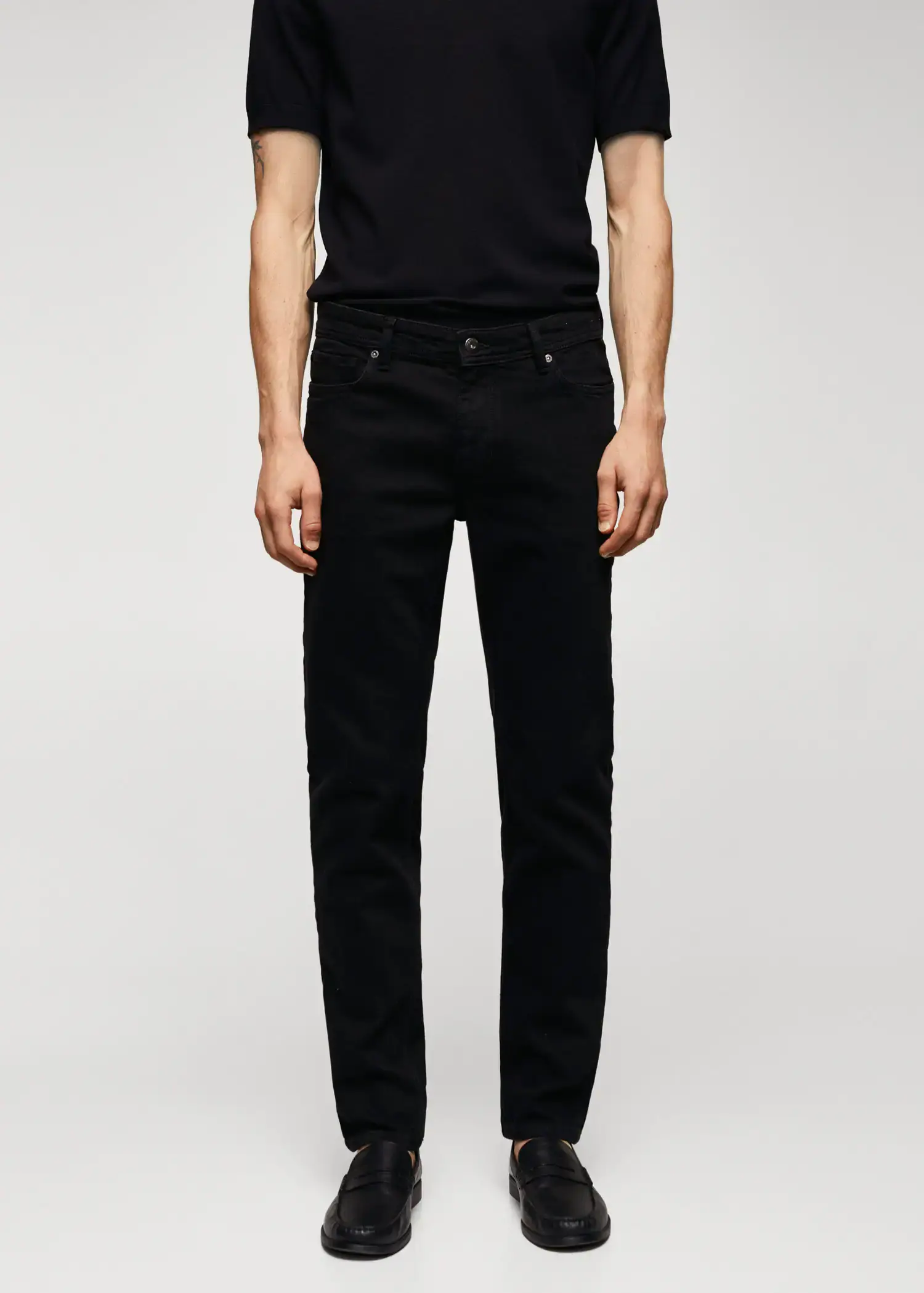 Mango Jan slim-fit jeans. a man wearing black jeans and a black shirt. 