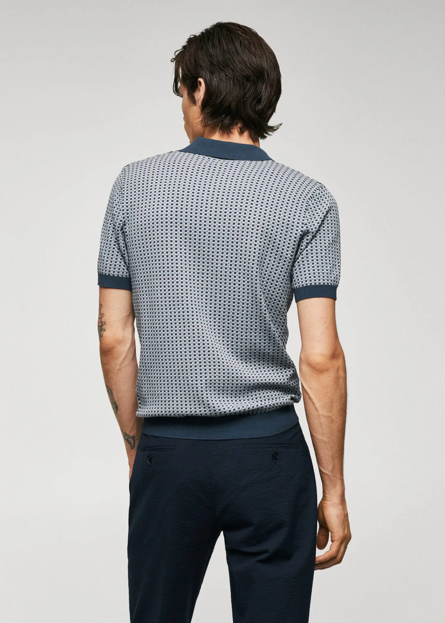 Mango Fine-knit polo shirt with geometric structure. a man wearing a blue and white patterned shirt. 
