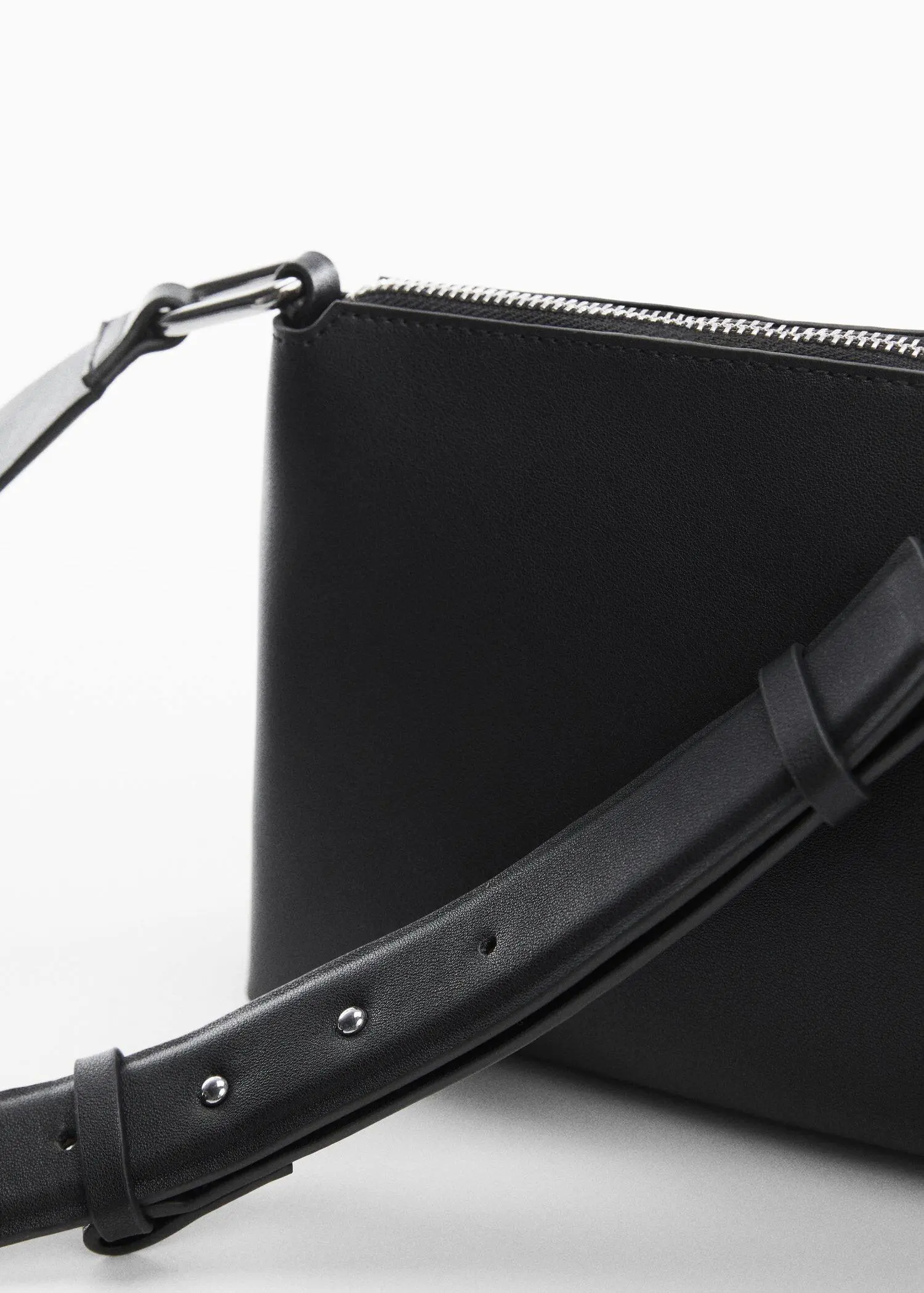 Mango Leather-effect shoulder bag. a close-up of a black purse with a black strap. 