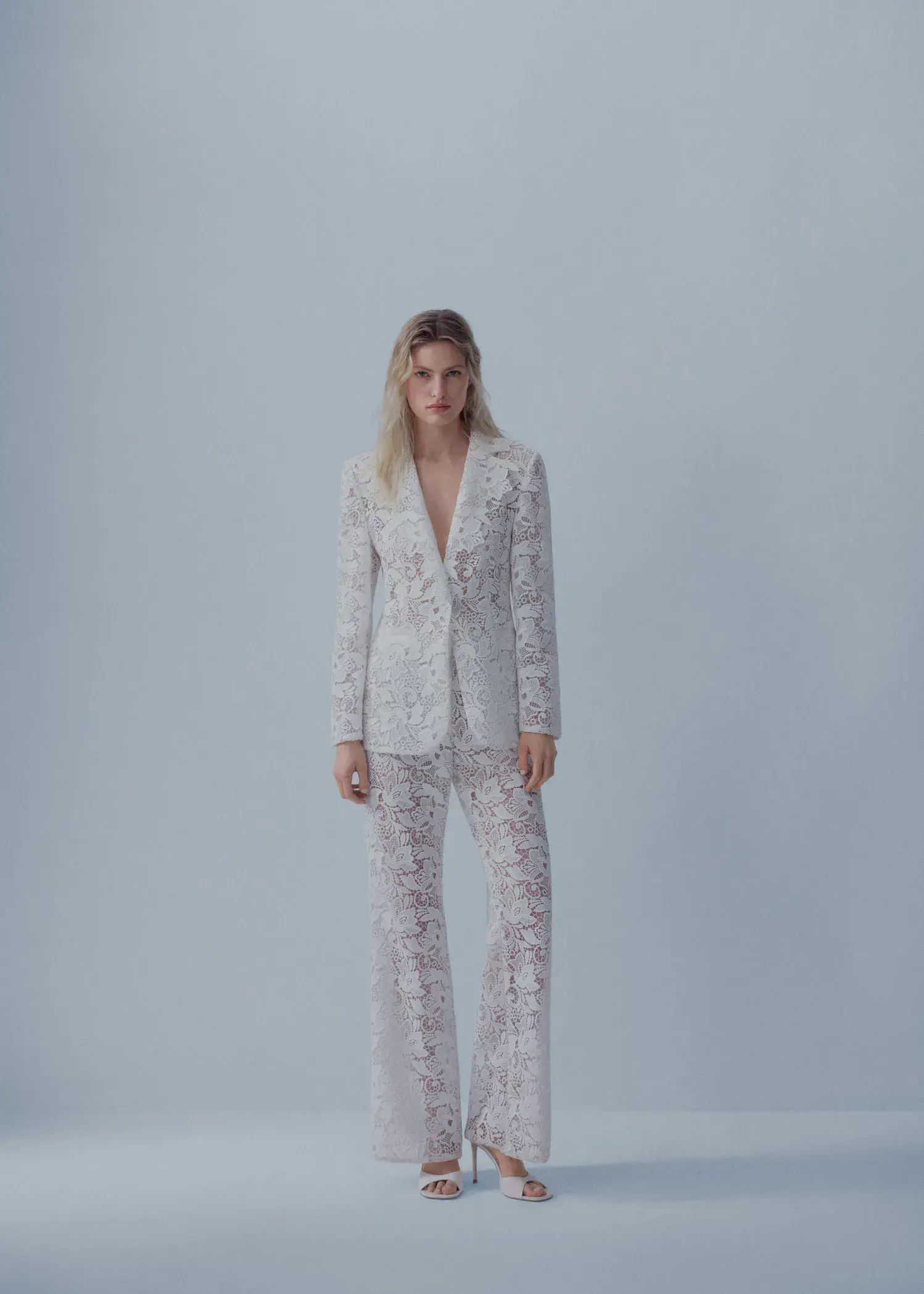 Mango Guipure suit blazer. a woman in a white suit standing in front of a white wall. 