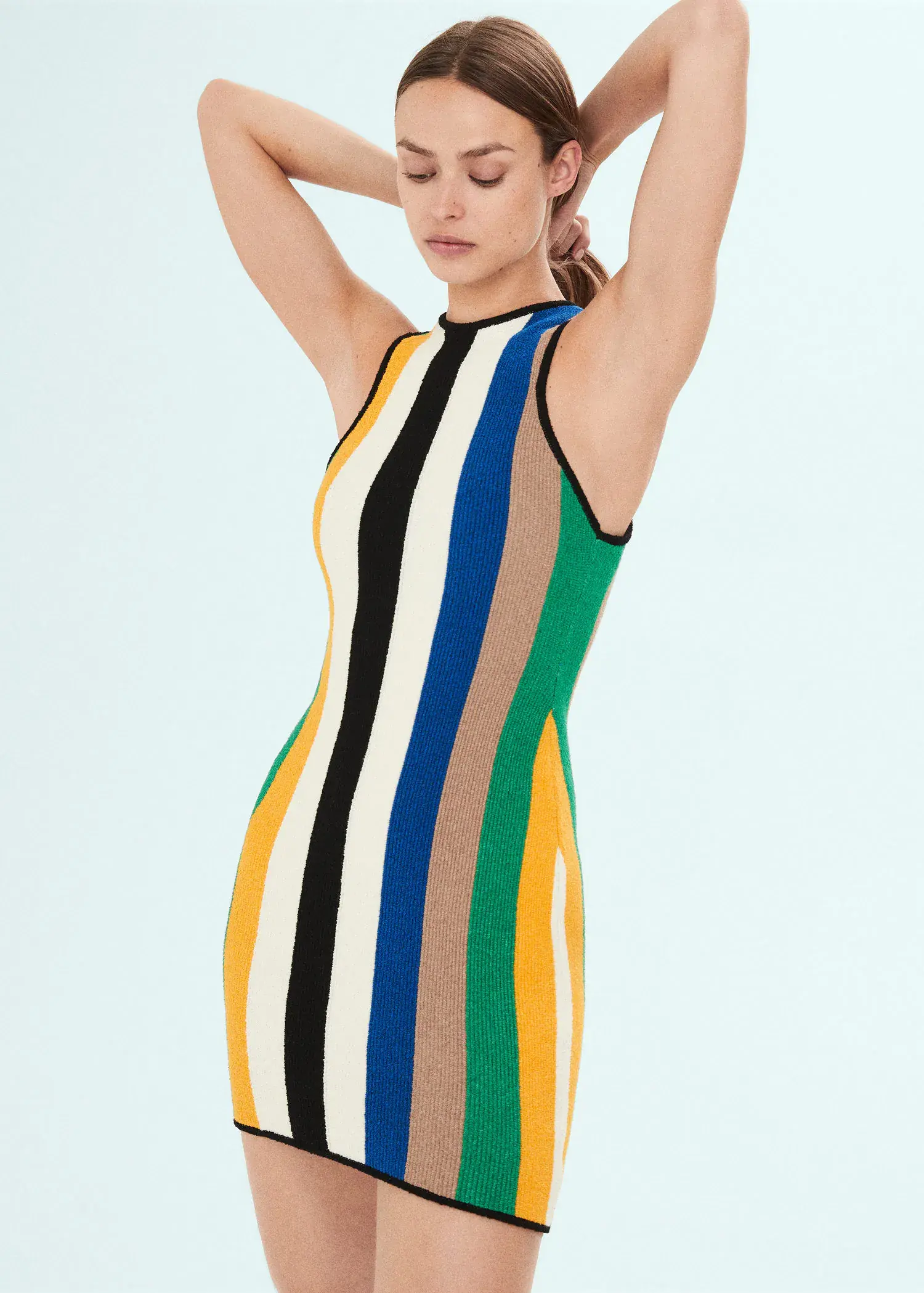 Mango Multi-colored midi knitted dress. a woman in a striped dress holding her head. 
