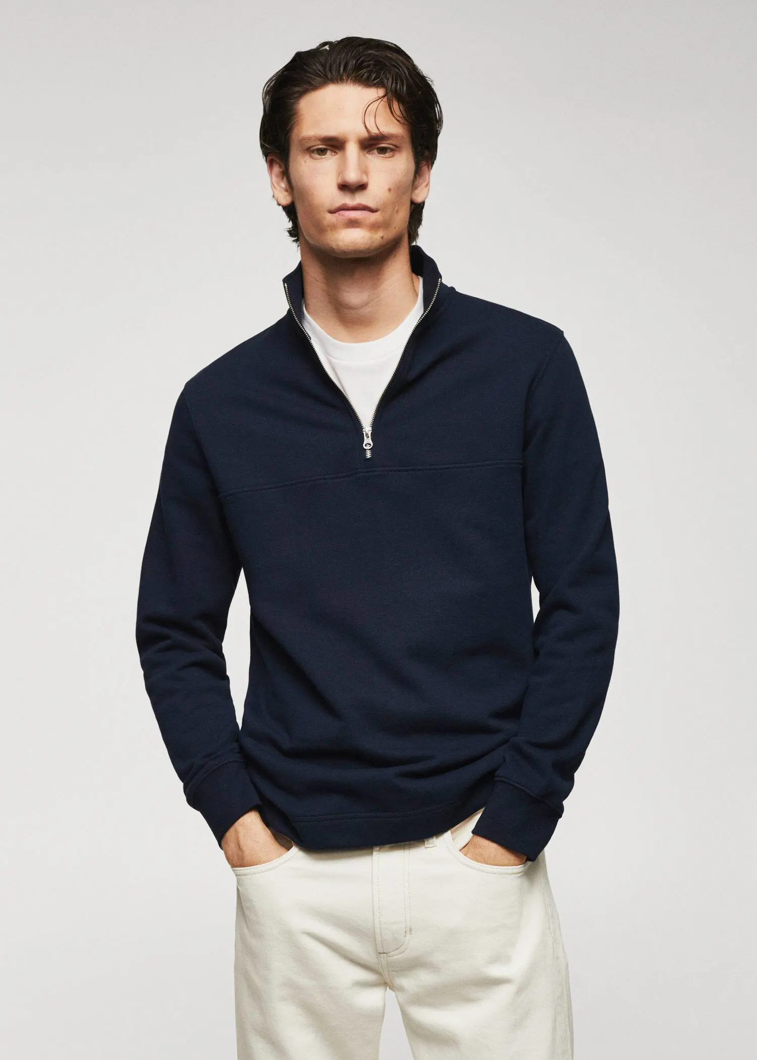 Mango Cotton sweatshirt with zip neck. a man wearing a black sweater and white pants. 