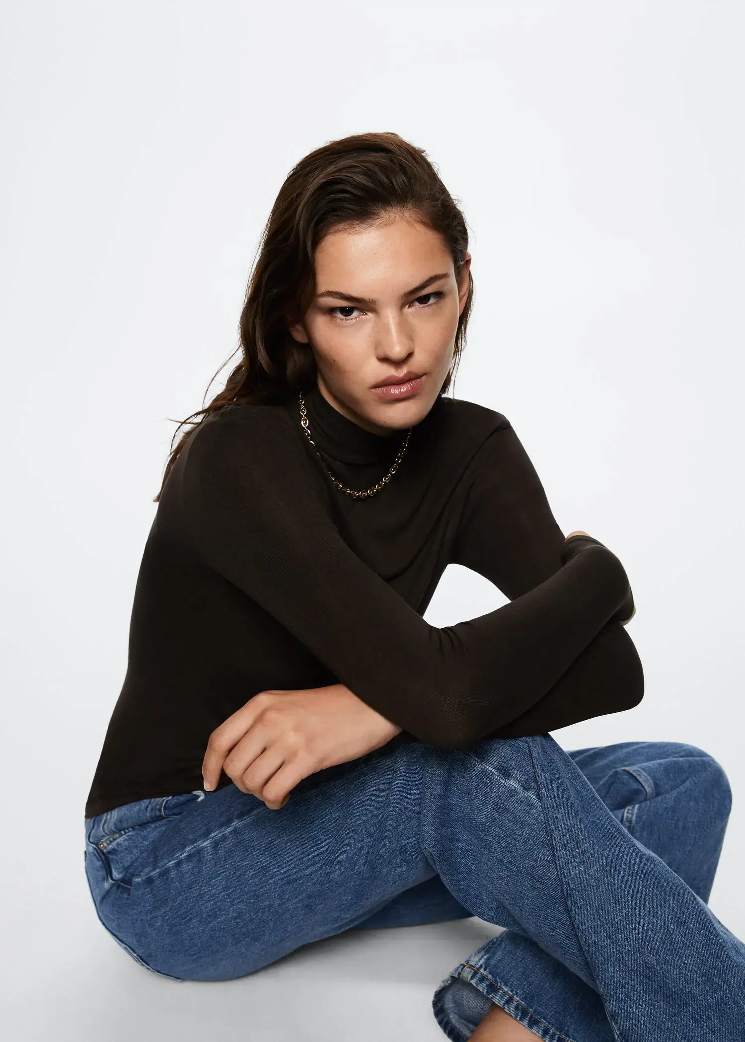 Mango Turtleneck long-sleeved t-shirt. a woman sitting on the ground wearing jeans and a sweater. 