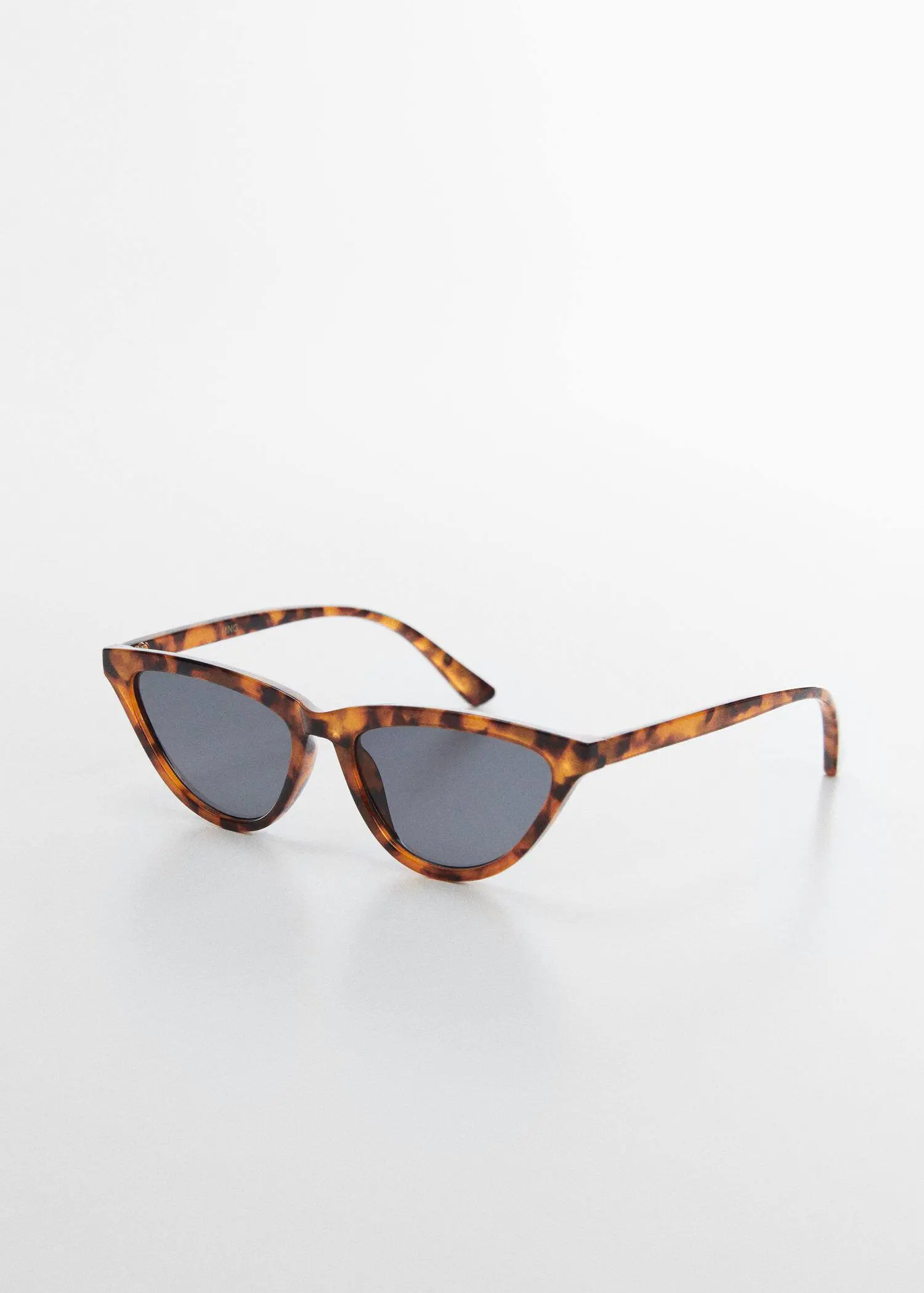 Mango Retro style sunglasses. a pair of sunglasses sitting on top of a white table. 