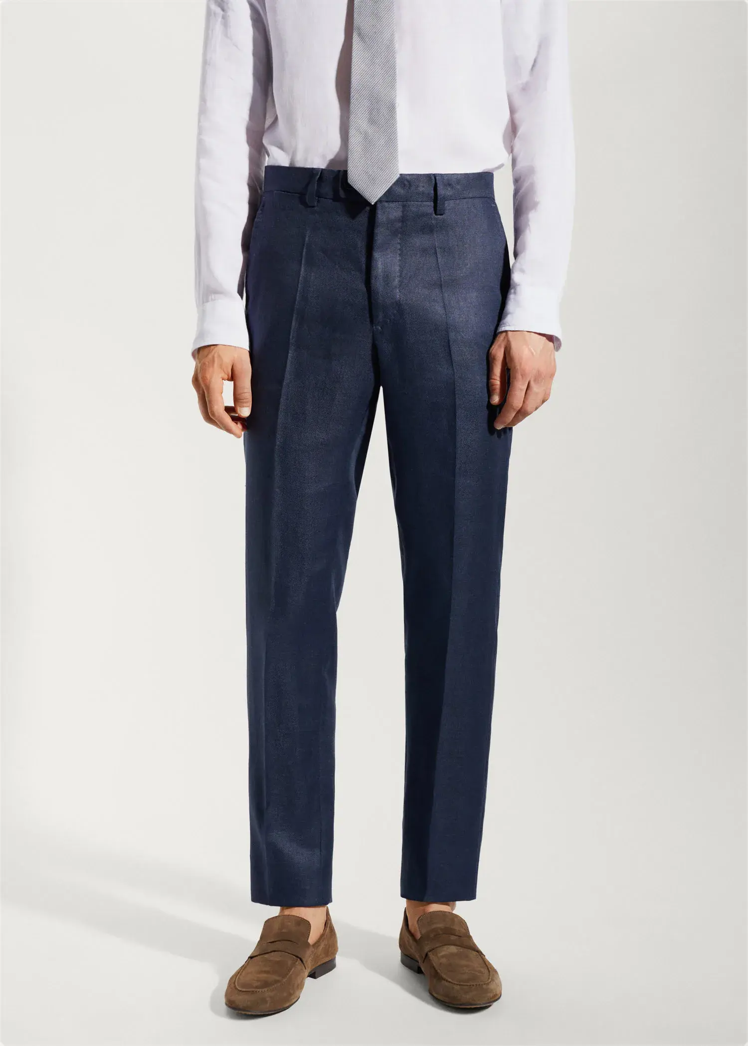 Mango 100% linen suit trousers. a man wearing a suit and tie standing in front of a wall. 