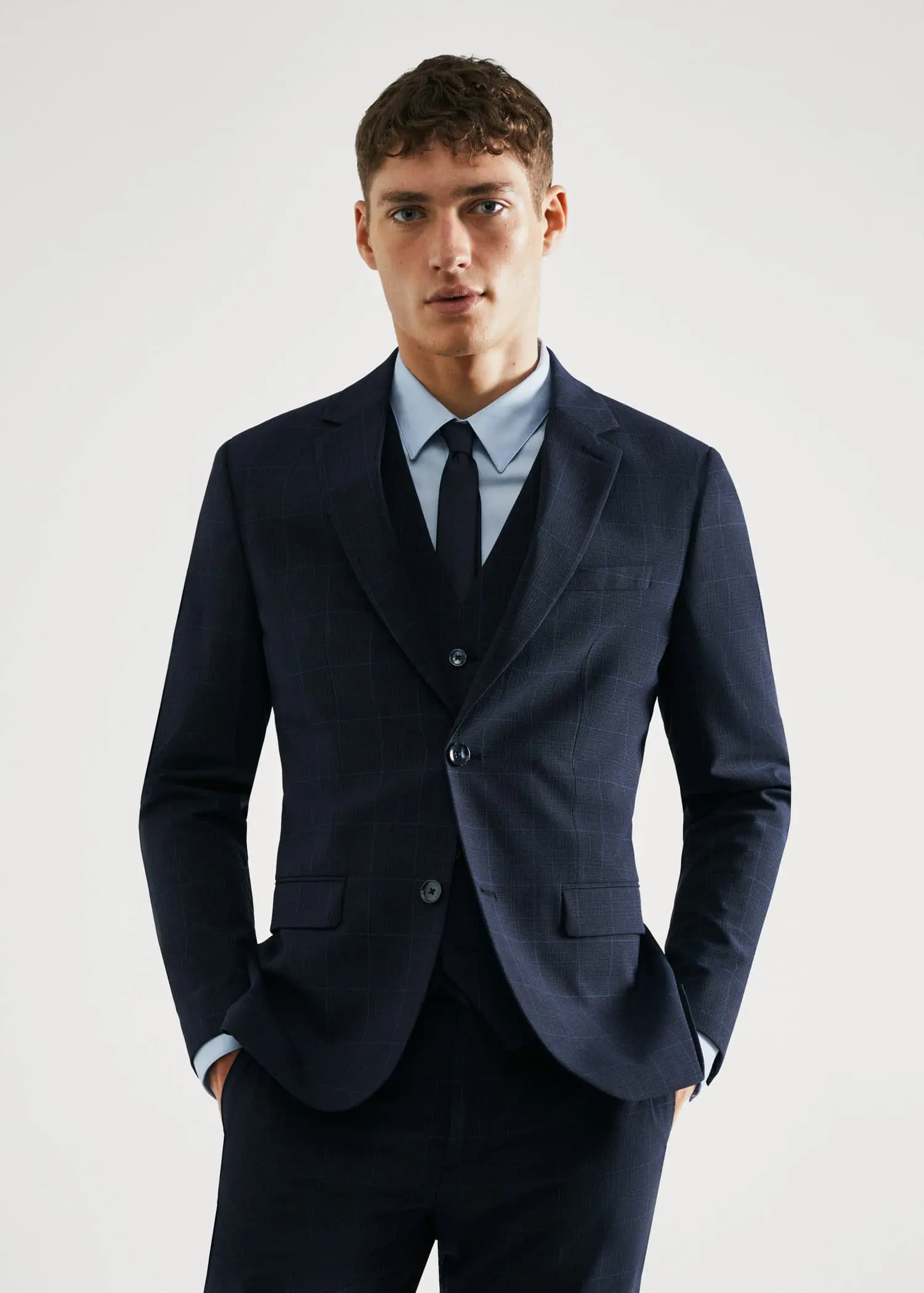 Mango Super slim-fit check suit jacket. a man wearing a suit and tie standing with his hands in his pockets. 