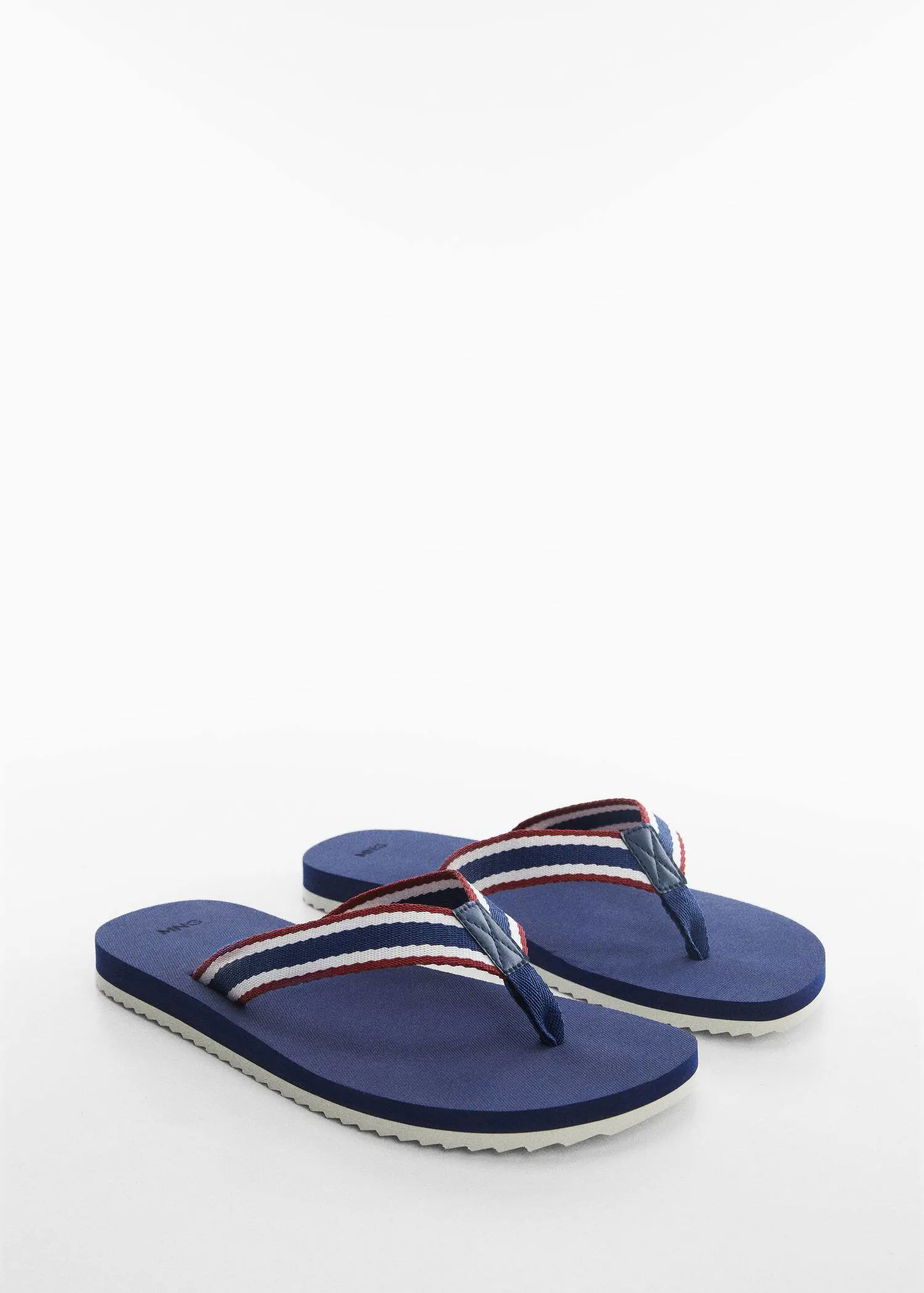 Mango Flip-flops with contrasting colour straps. a pair of flip flops on a white surface. 