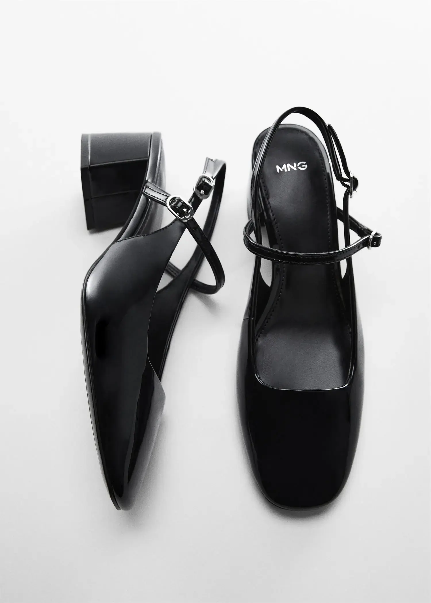 Mango Block heel shoe. a pair of black shoes sitting next to each other on a table. 
