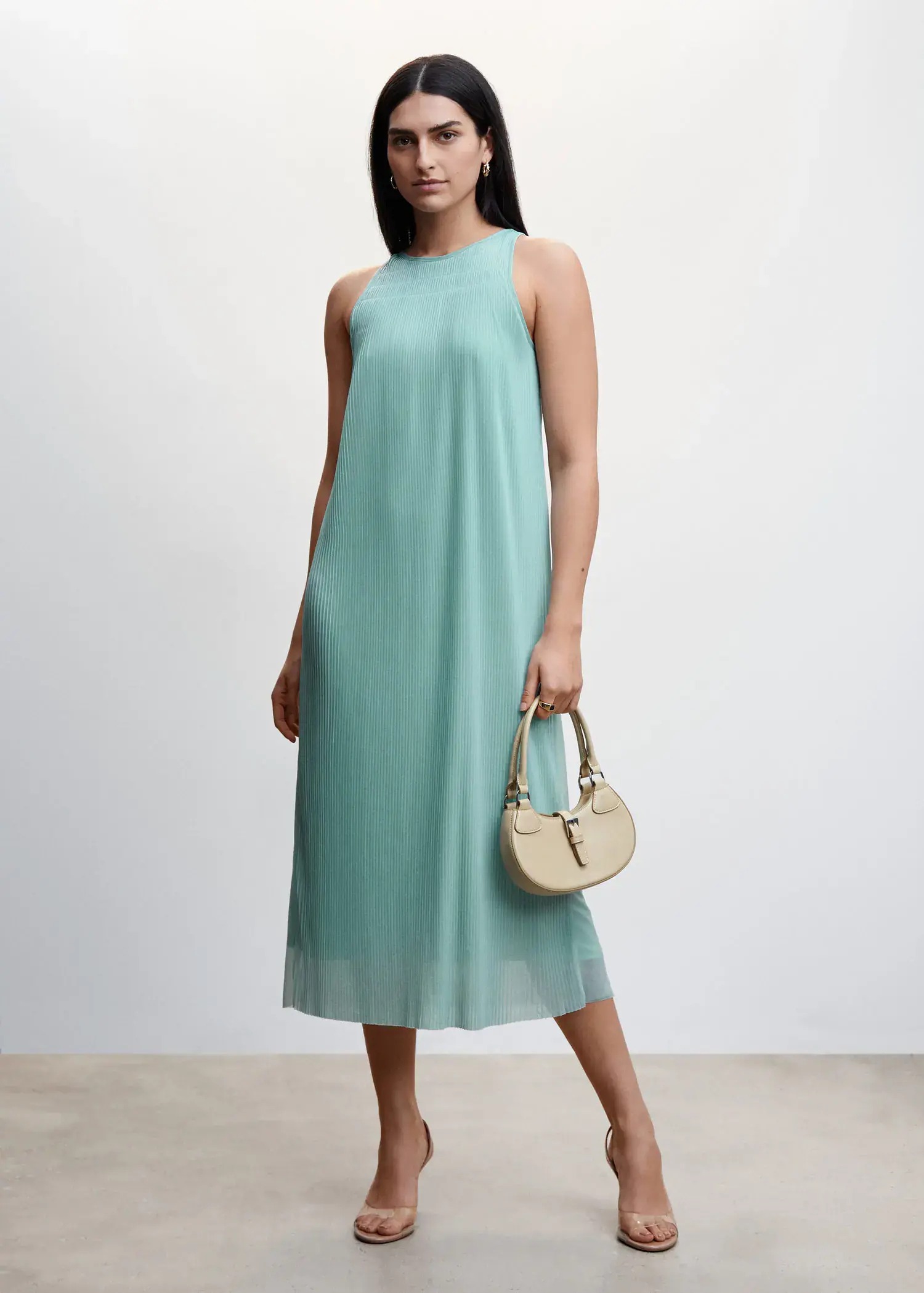Mango Textured shift dress. a woman wearing a dress holding a purse. 