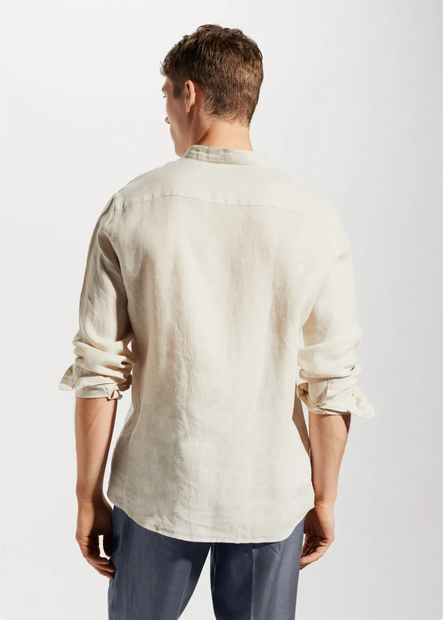 Mango 100% linen Mao collar shirt. a man in a white shirt is standing in front of a white wall. 