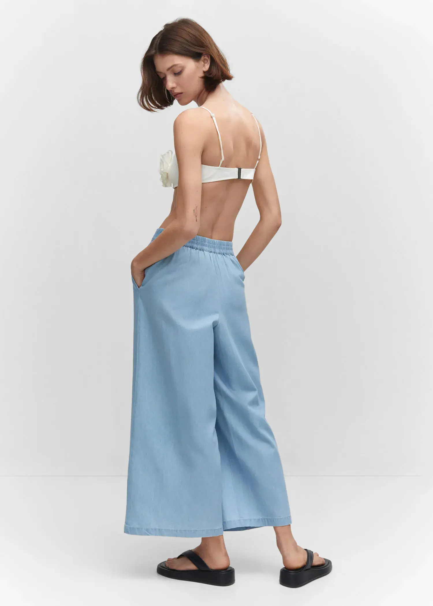 Mango 100% cotton culotte trousers . a woman in a white top and light blue pants. 