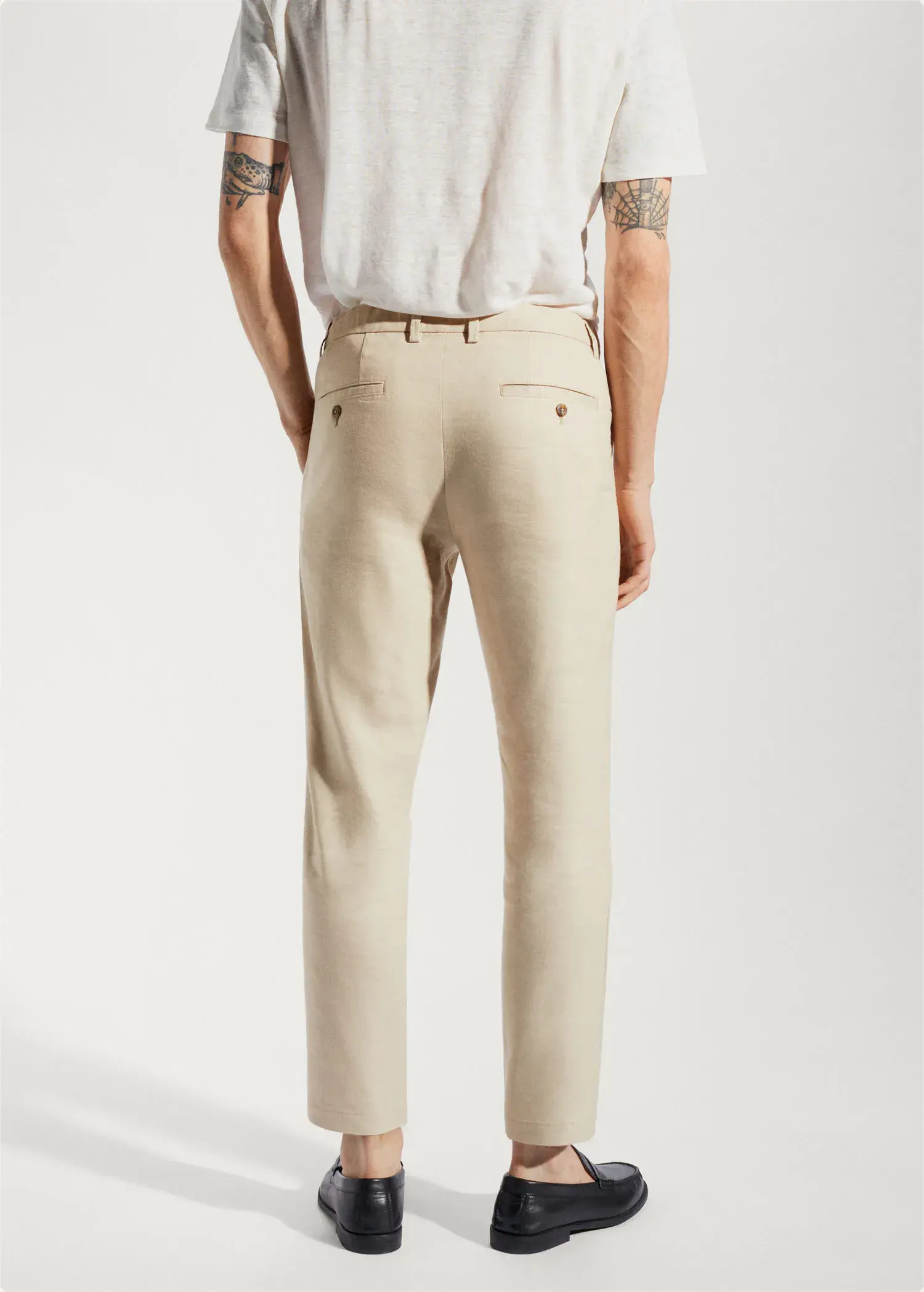 Mango Linen slim-fit pants with inner drawstring. a person wearing a white shirt and beige pants. 