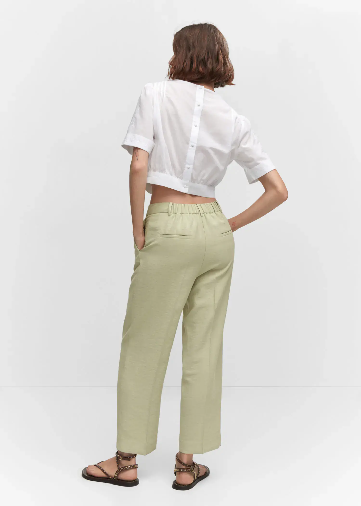 Mango Pleat straight trousers. a woman wearing a white shirt and a pair of pants. 