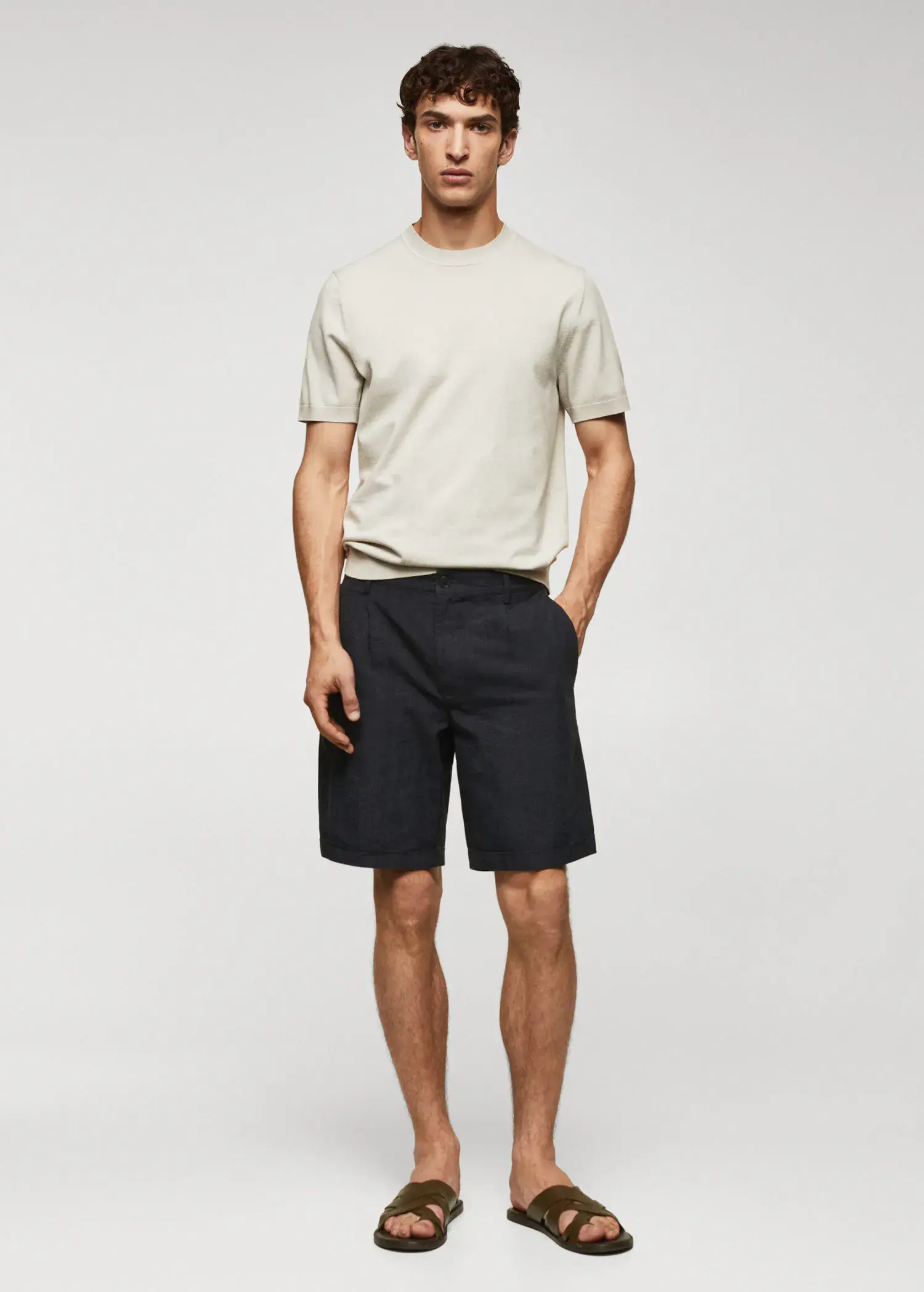 Mango Prince of Wales printed cotton-linen bermuda shorts. a young man wearing black shorts and a white t-shirt. 