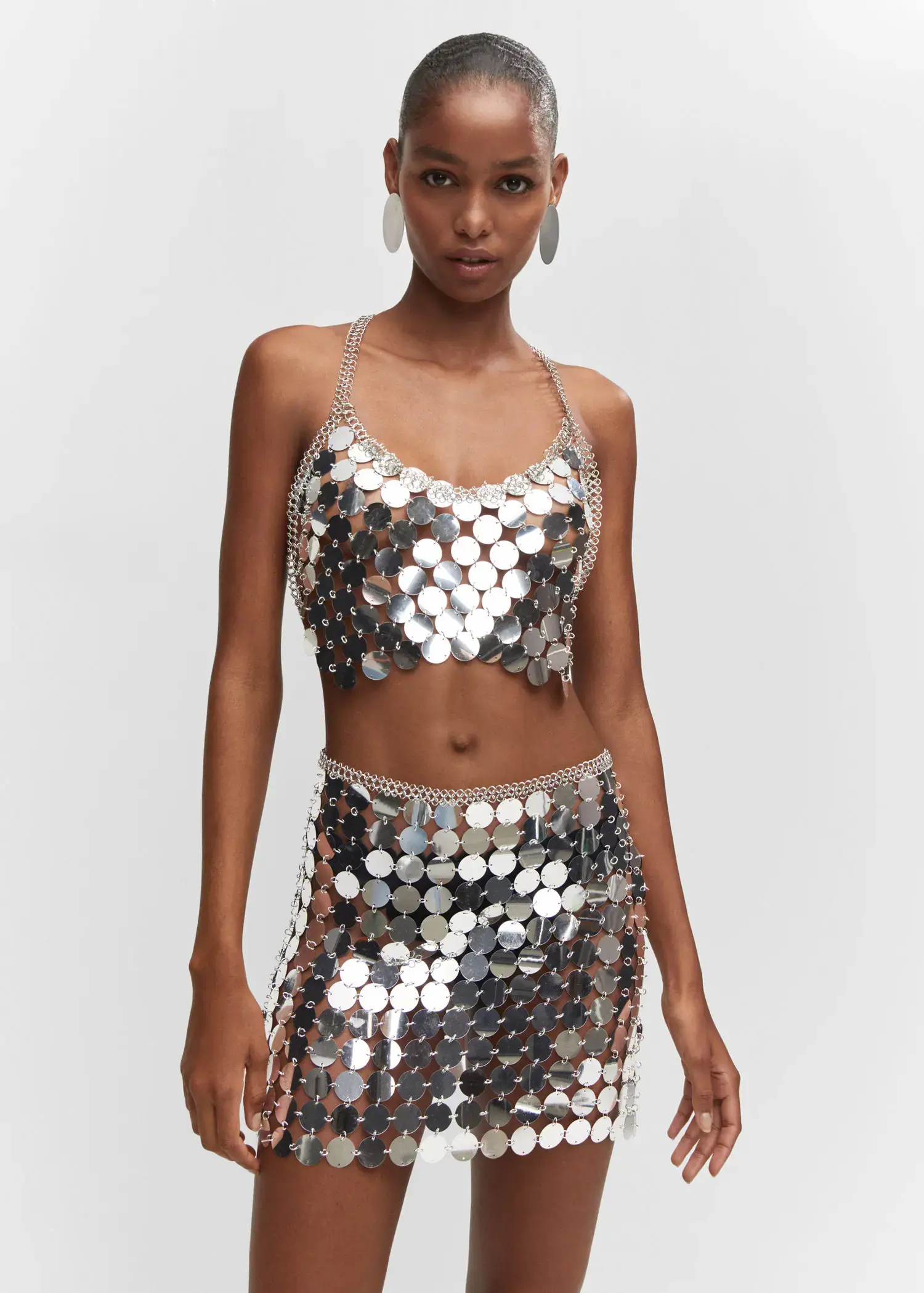 Mango Metallic disc skirt. a woman wearing a silver sequined outfit. 