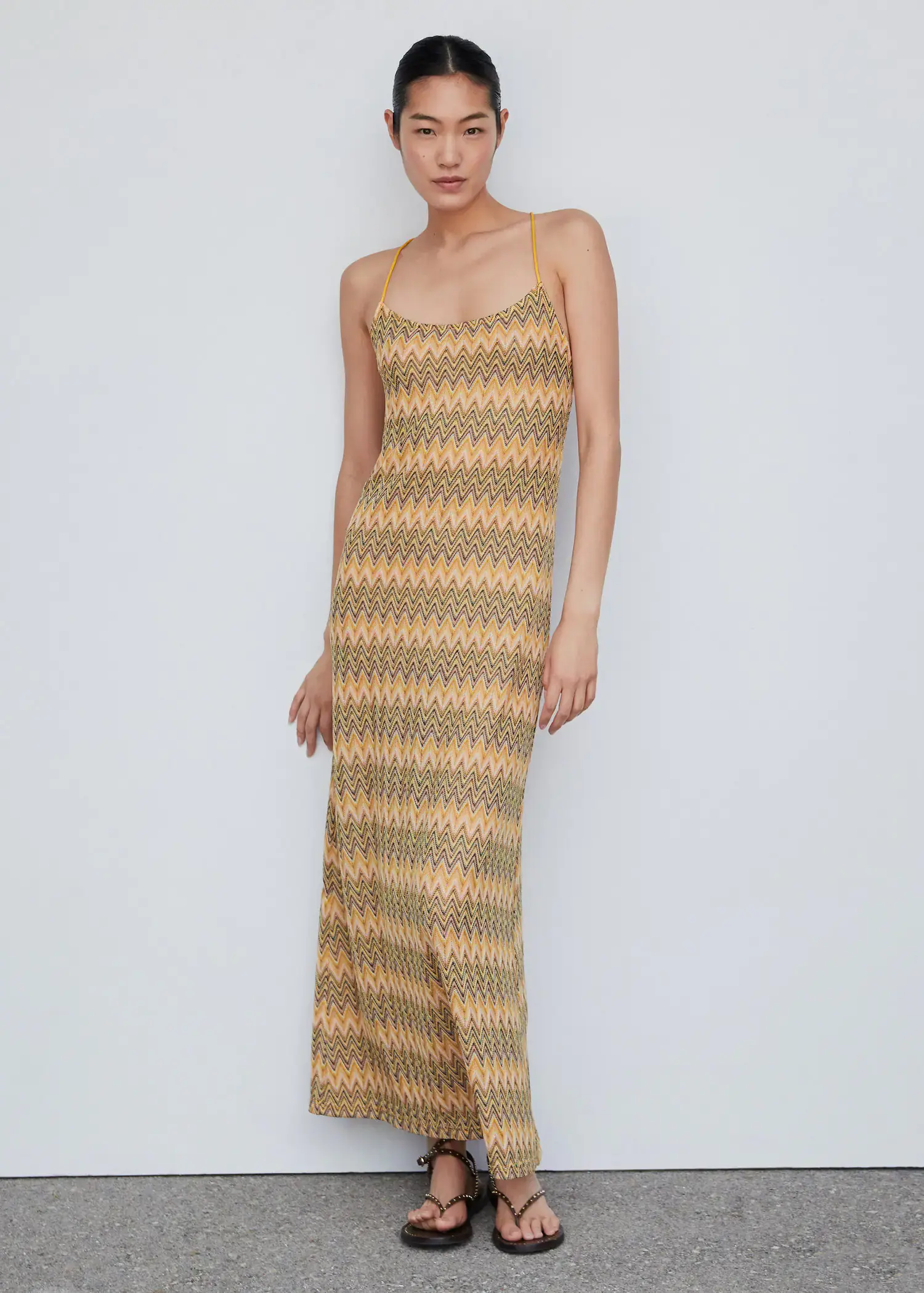 Mango Geometric pattern dress. a woman wearing a long dress standing in a room. 