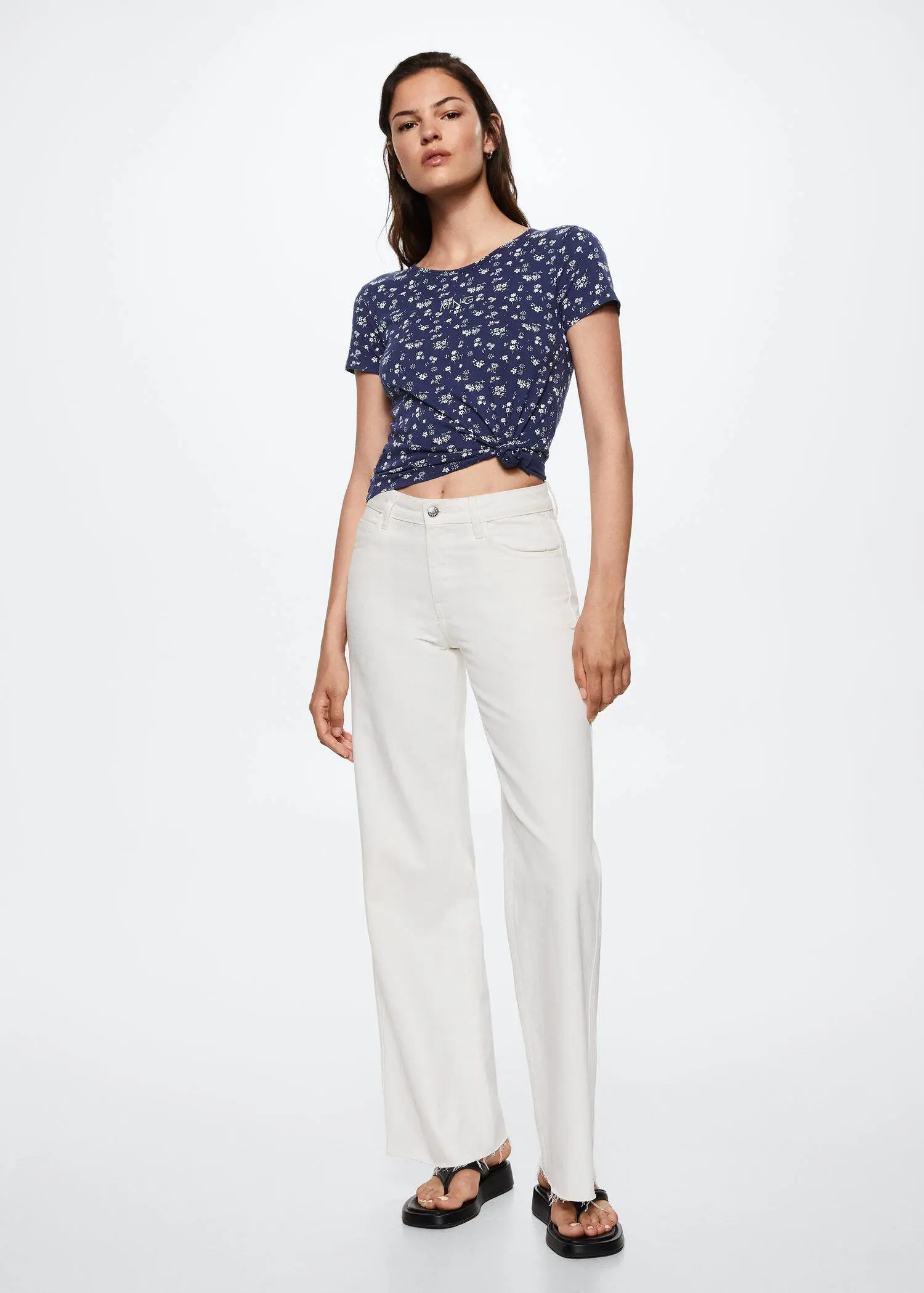 Mango Printed cotton-blend T-shirt. a woman wearing white pants and a blue top. 