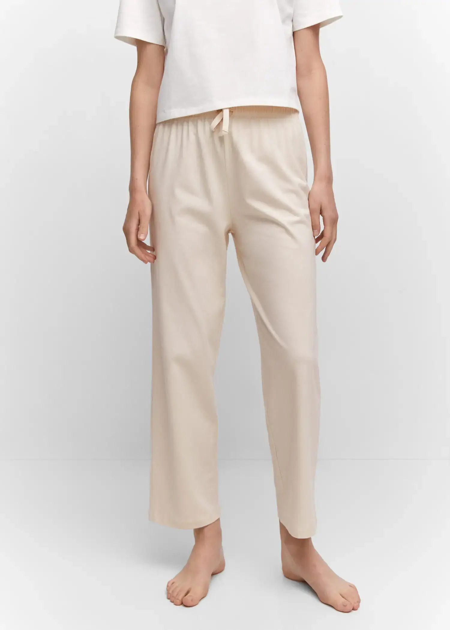 Mango Cotton-knit trousers. a person wearing a pair of white pants. 