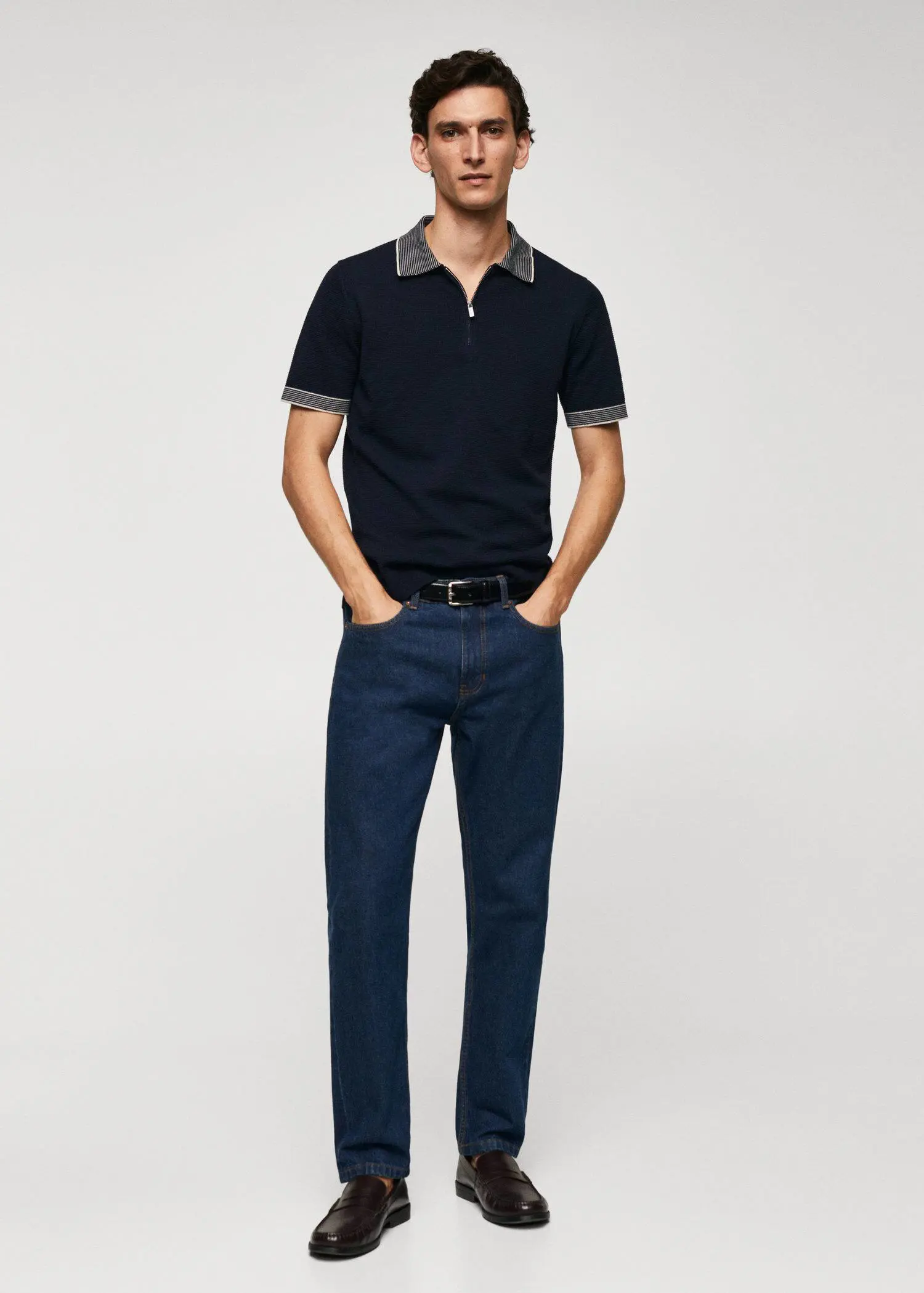 Mango Fine-knit polo shirt with zip. a man in a black polo shirt and blue jeans. 