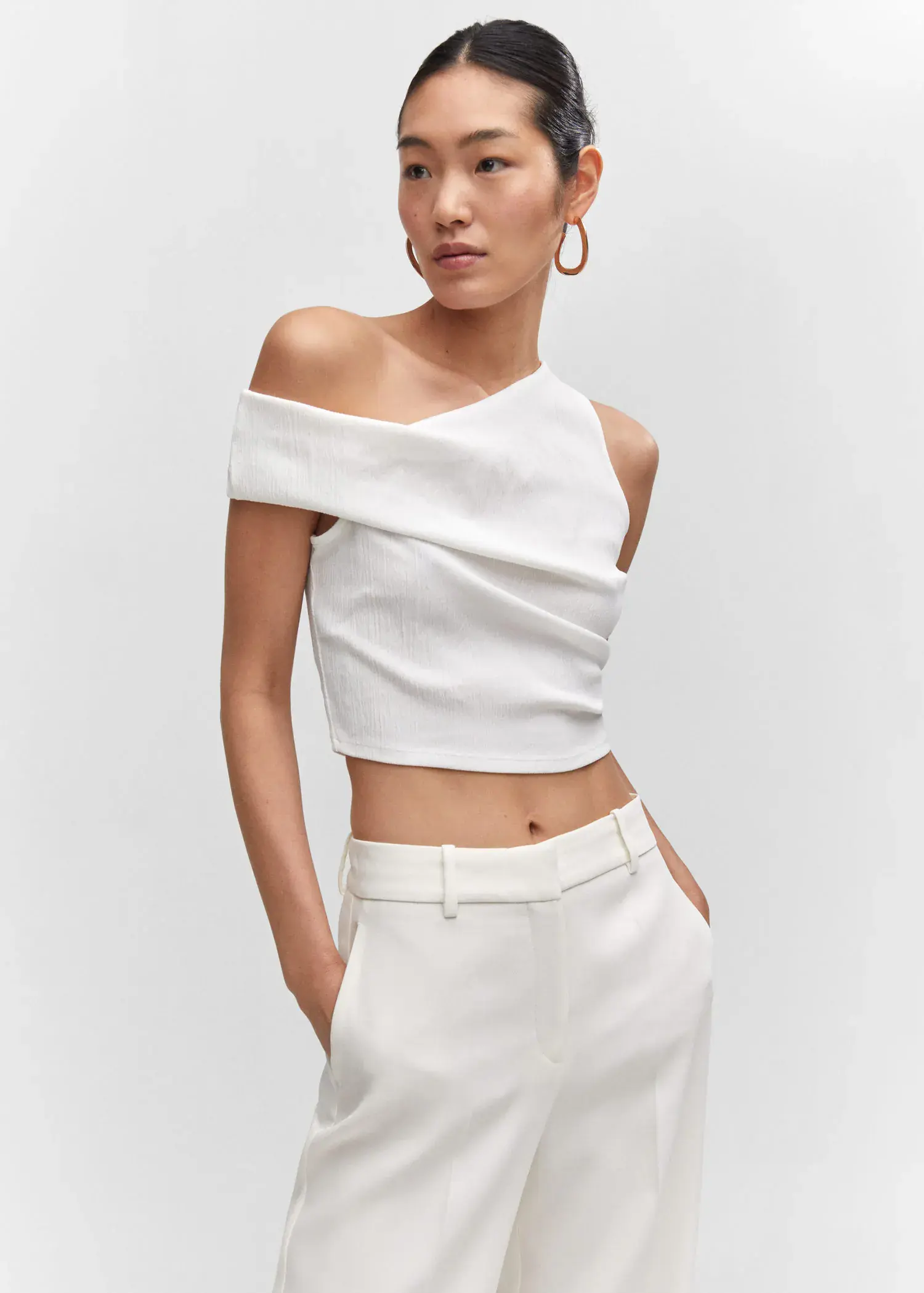 Mango Asymmetrical textured top. a woman in a white outfit posing for a picture. 
