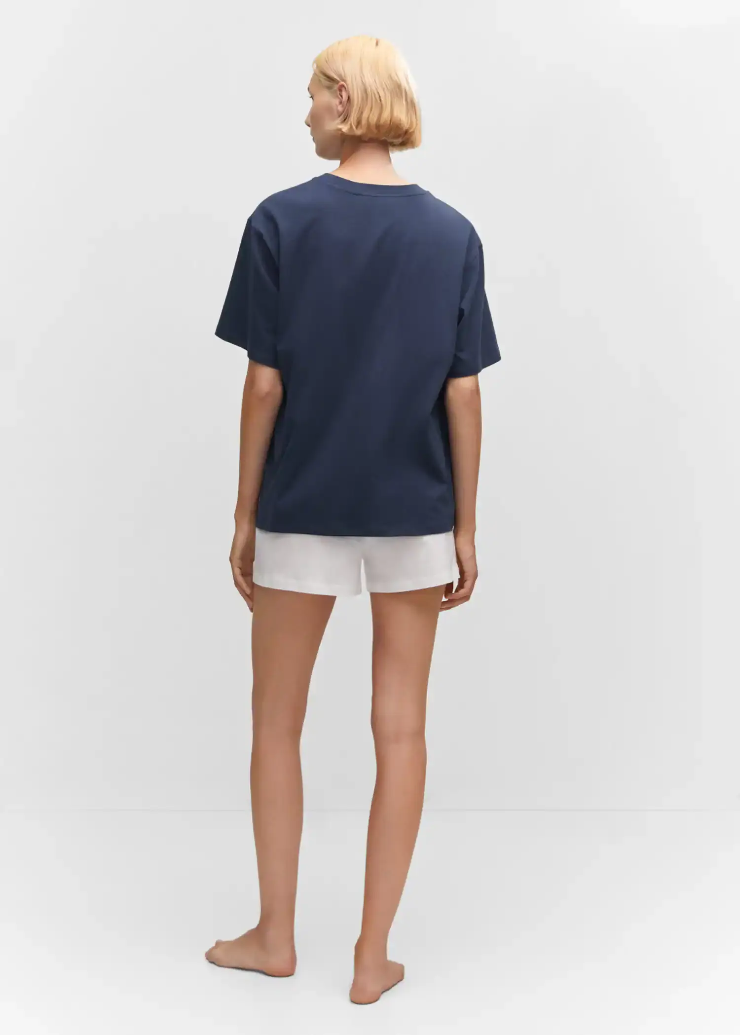 Mango Cotton shorts with elastic waist. a person wearing white shorts and a blue shirt. 