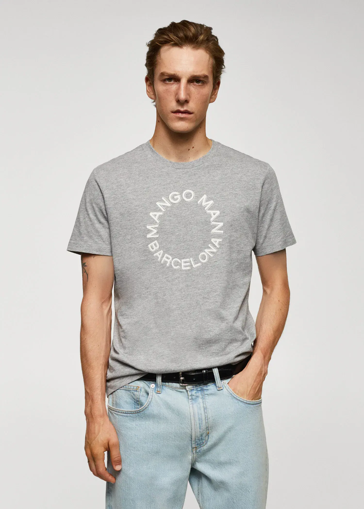 Mango 100% cotton t-shirt with logo. a man in a gray t-shirt and blue jeans. 