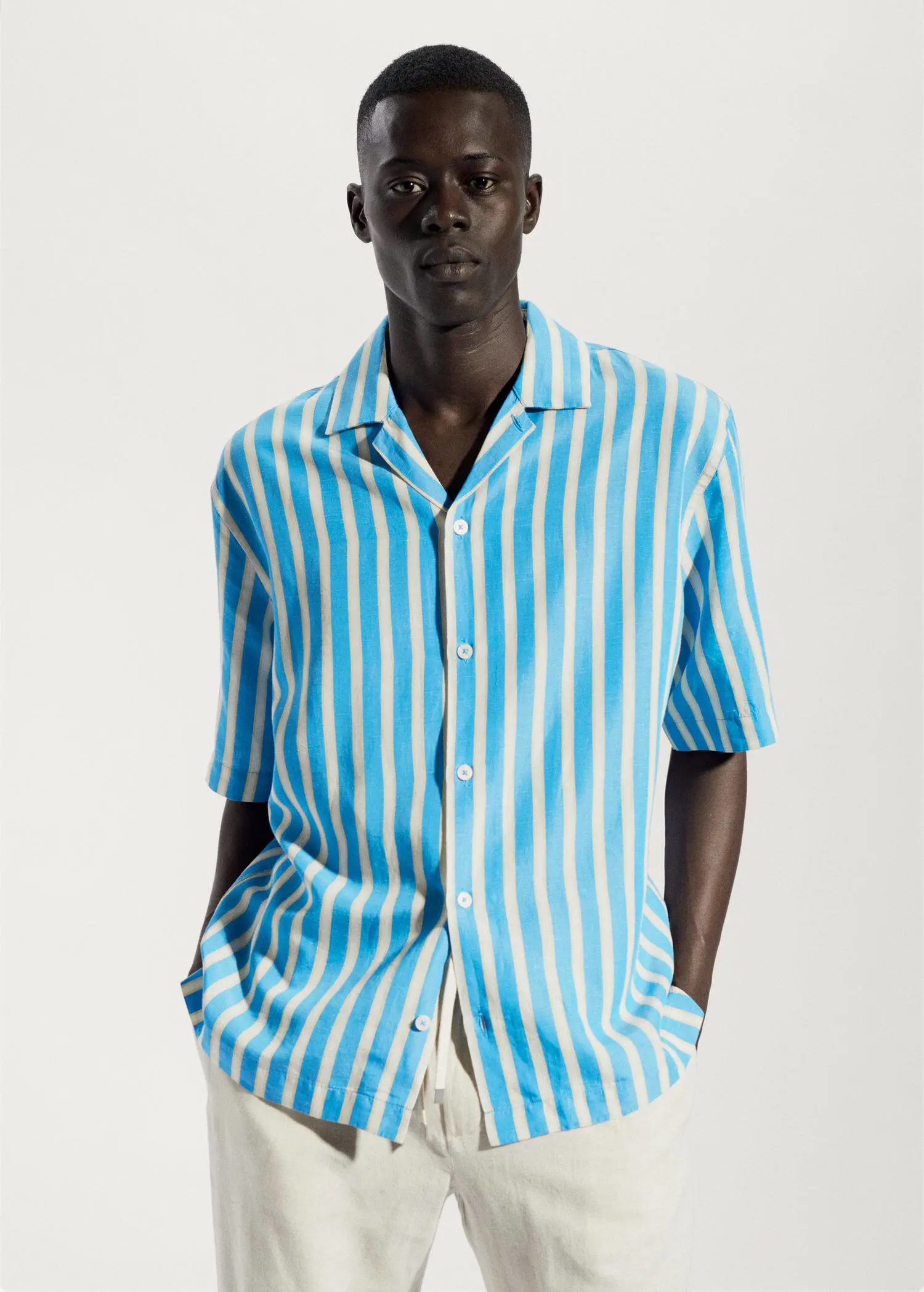 Mango Striped cotton linen shirt. a man wearing a blue and white striped shirt. 
