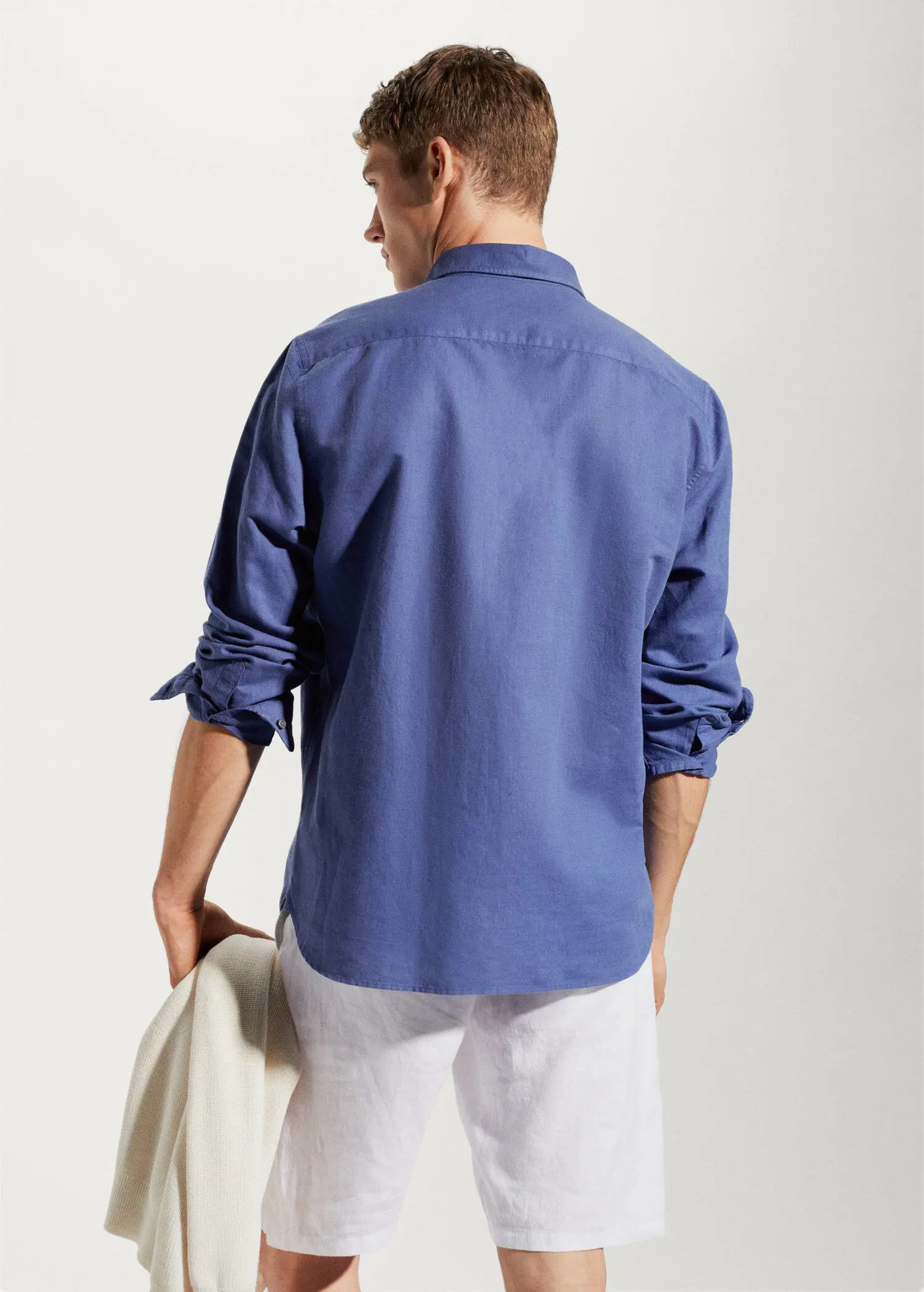 Mango Regular-fit linen cotton shirt. a man wearing a blue shirt and white pants. 