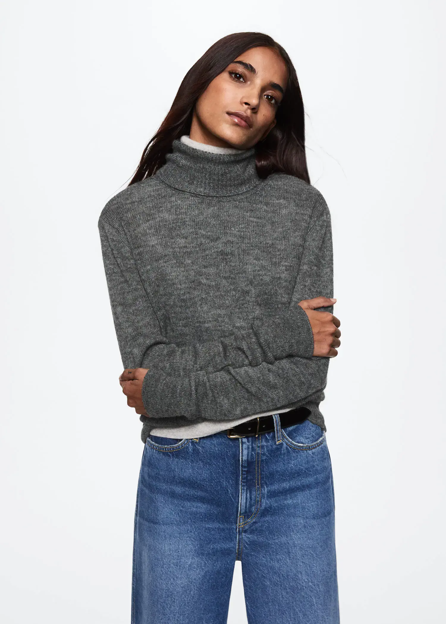 Mango Turtle neck sweater. a woman wearing a gray sweater and blue jeans. 