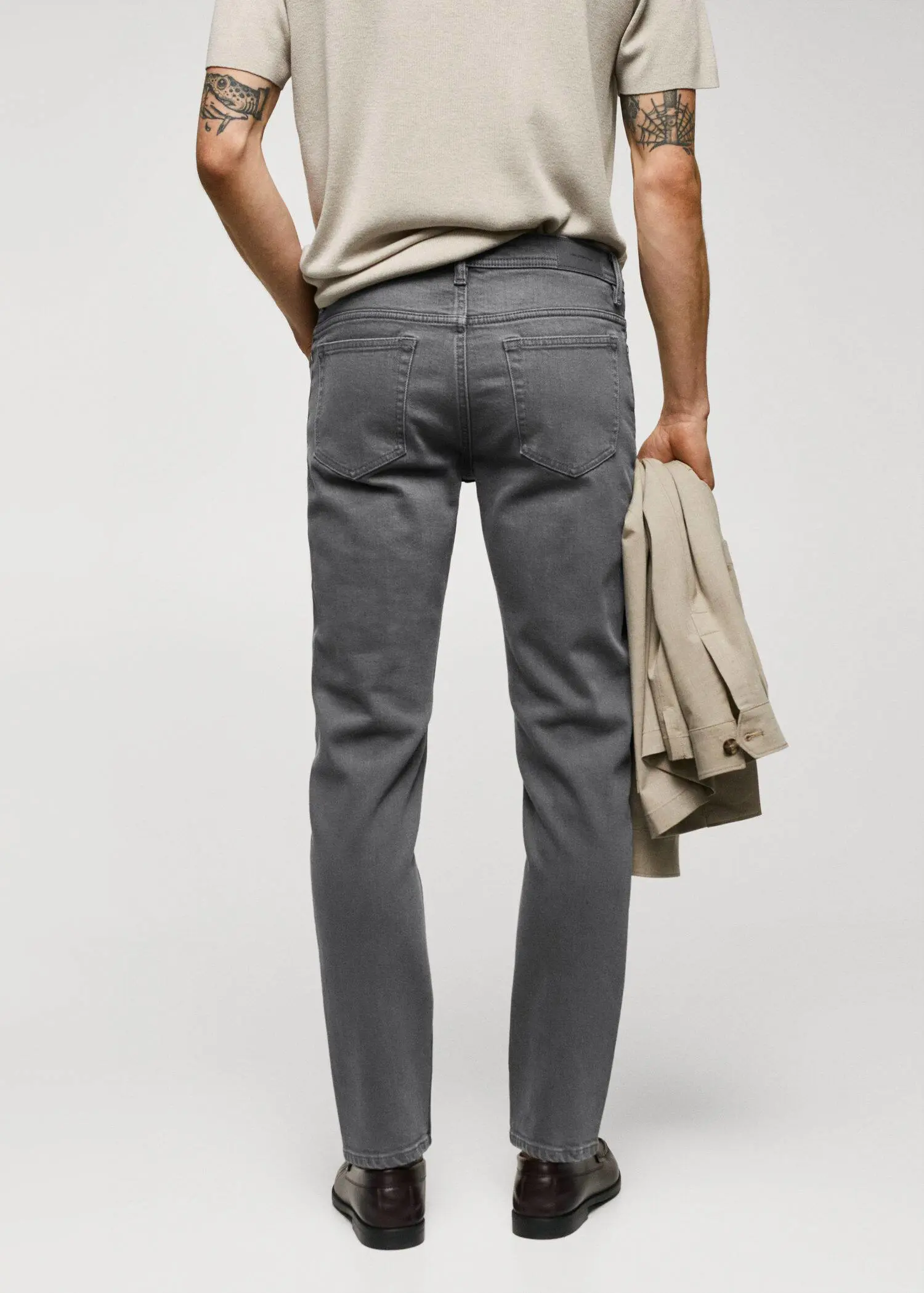 Mango Jan slim-fit jeans. a man is holding his hands behind his back. 