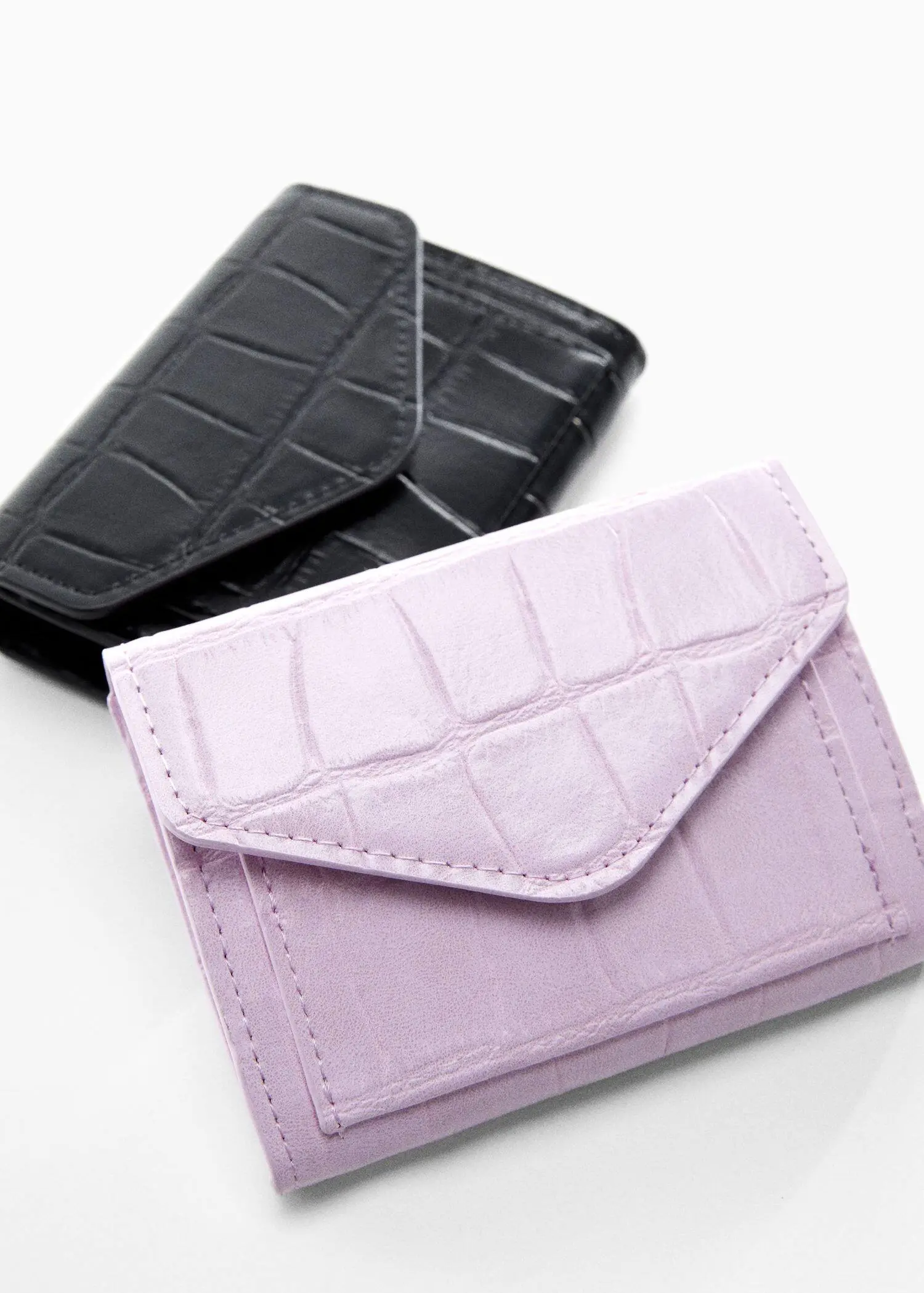 Mango Croc-effect flap purse. a black and a purple wallet sitting next to each other. 