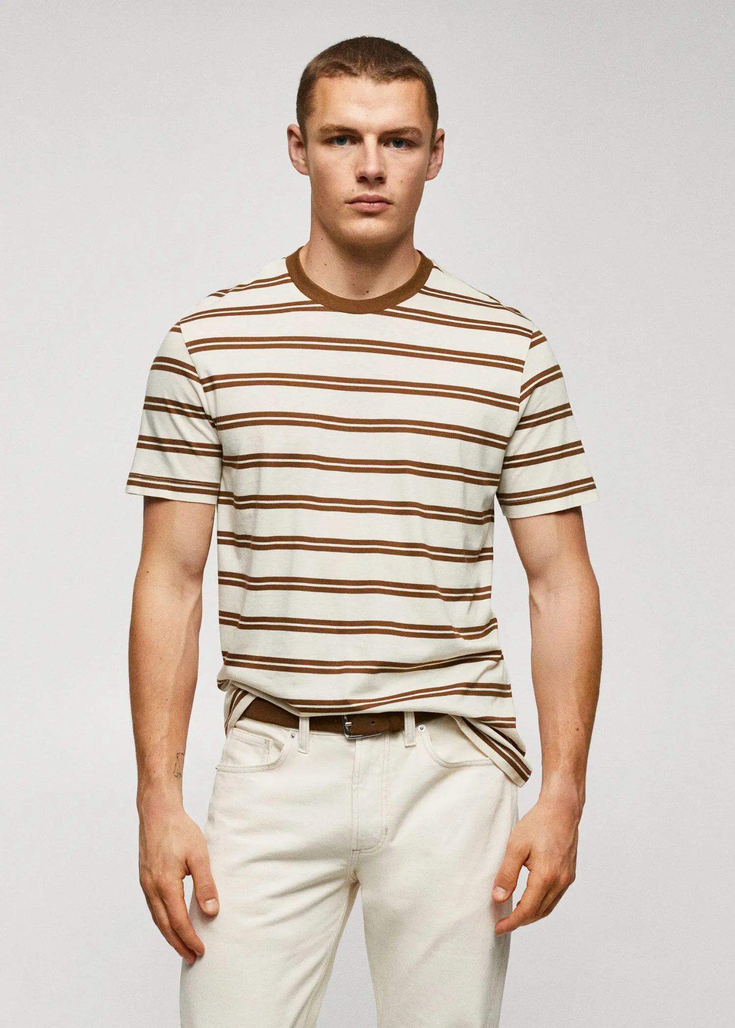 Mango Cotton-modal striped t-shirt. a man wearing a striped shirt and white pants. 