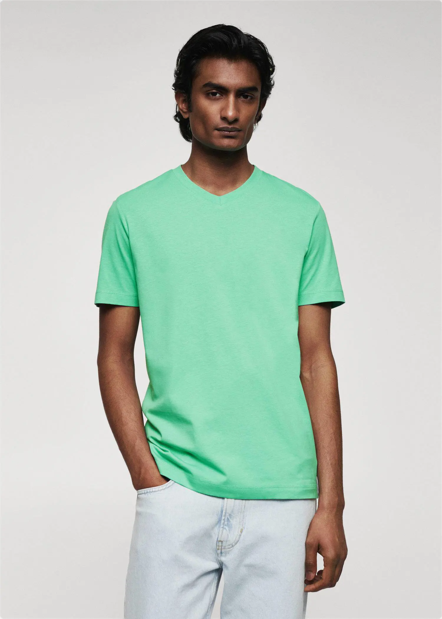 Mango 100% cotton V-neck t-shirt . a man in a green shirt is posing for a picture 