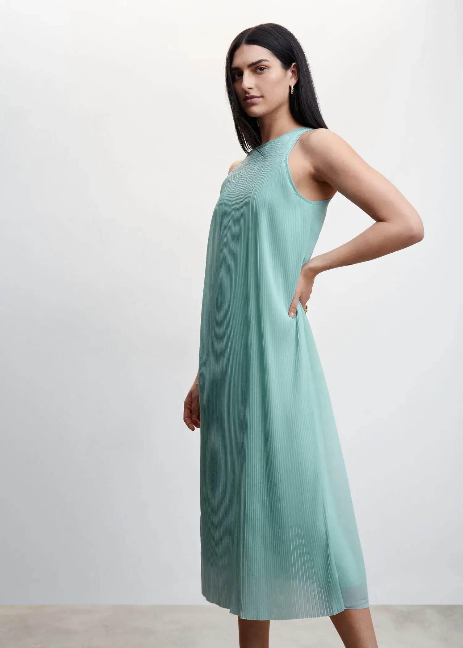 Mango Textured shift dress. a woman wearing a long blue dress standing next to a white wall. 