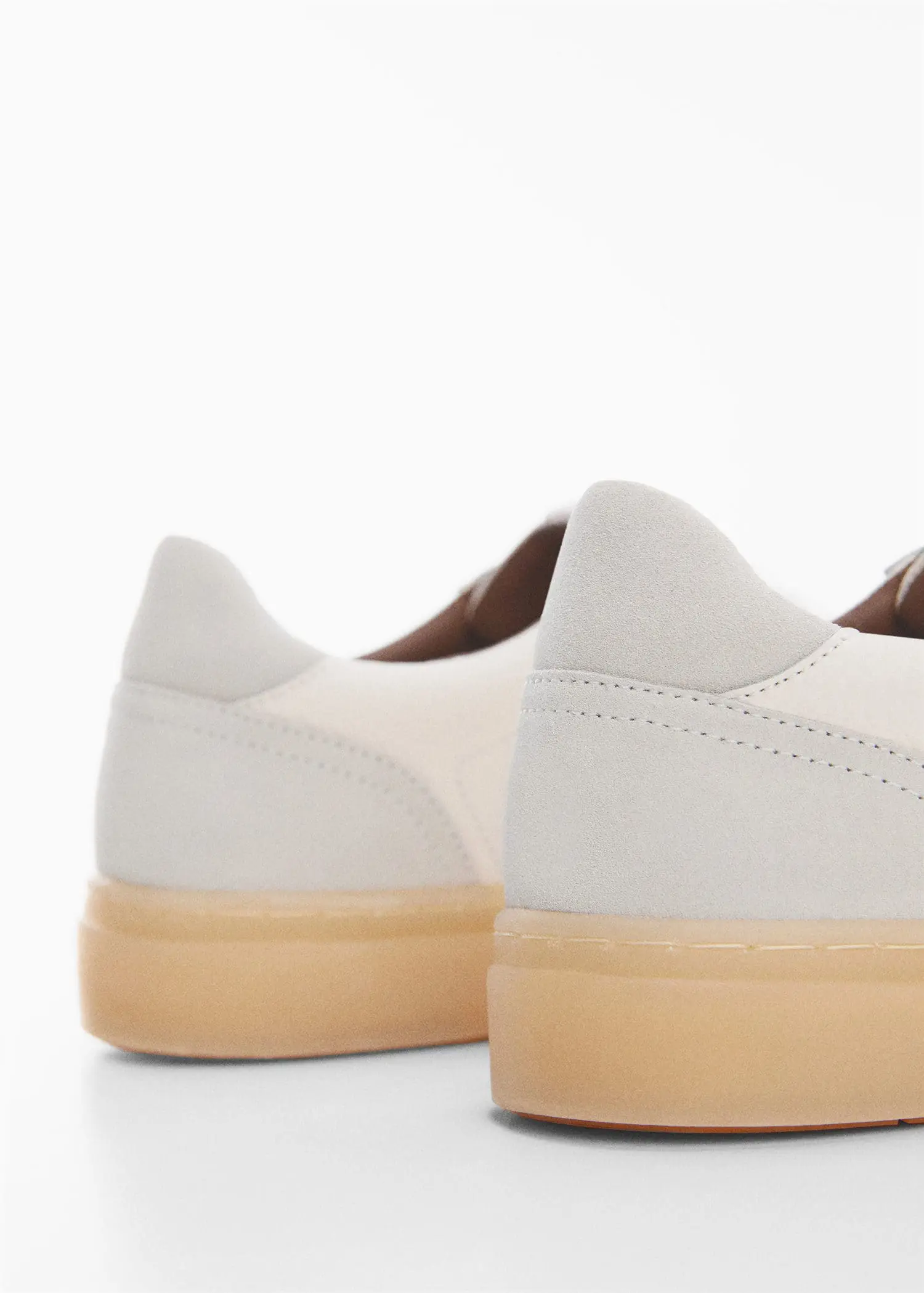 Mango Nappa leather trainers. a close up view of a pair of white shoes. 