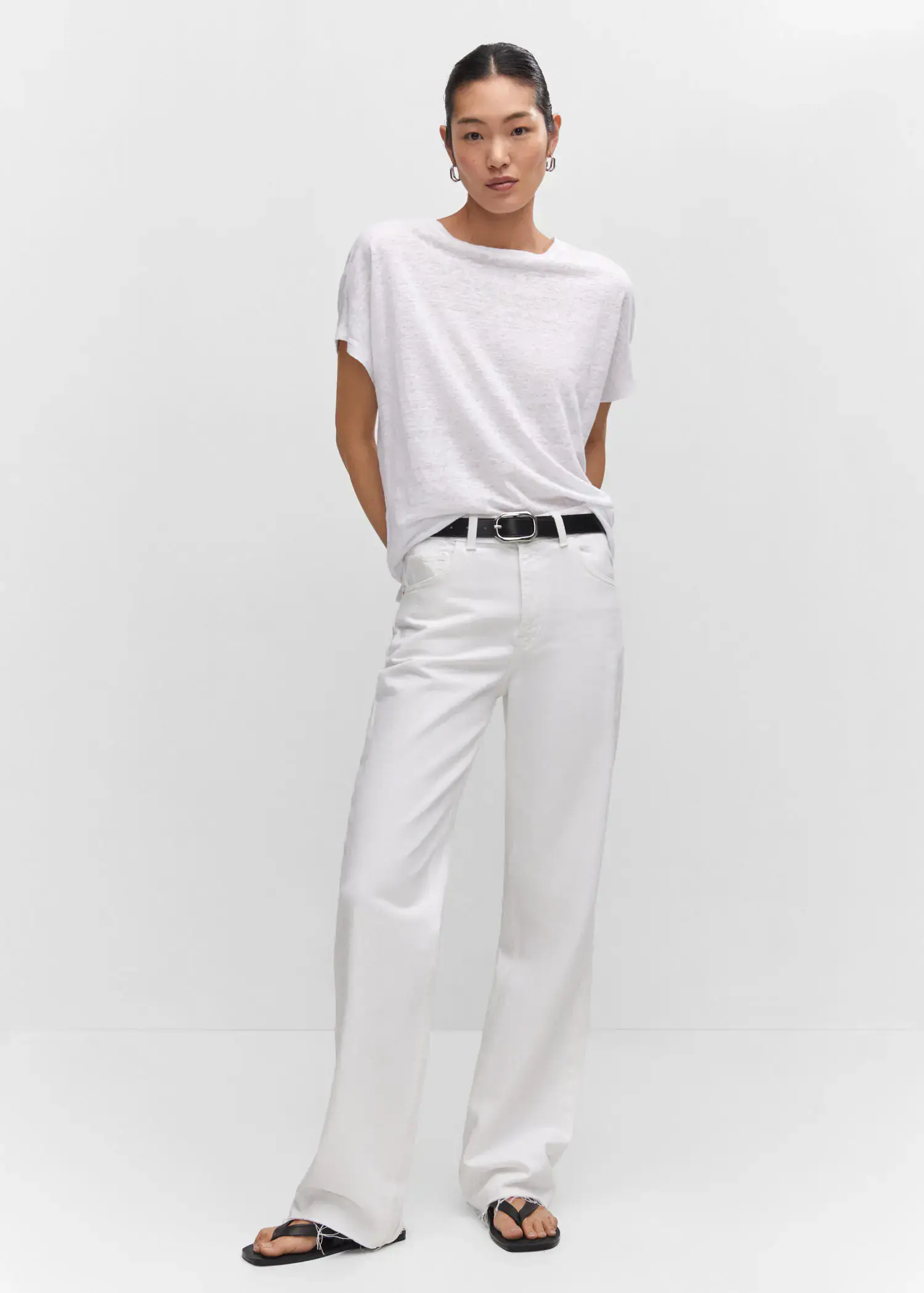Mango Oversized linen t-shirt. a woman in white shirt and white pants. 