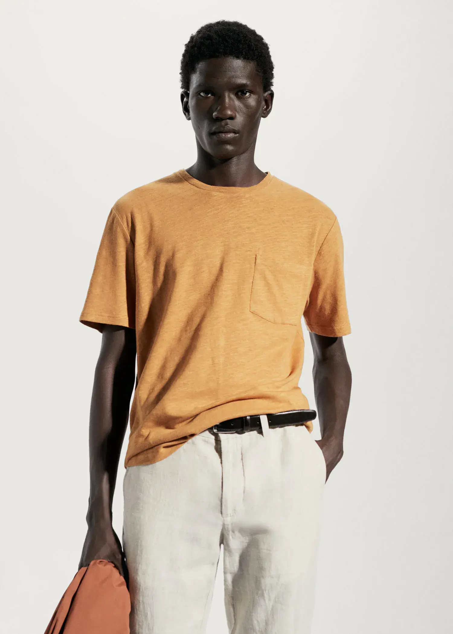 Mango Cotton-linen pocket t-shirt. a man in a yellow shirt and white shorts. 
